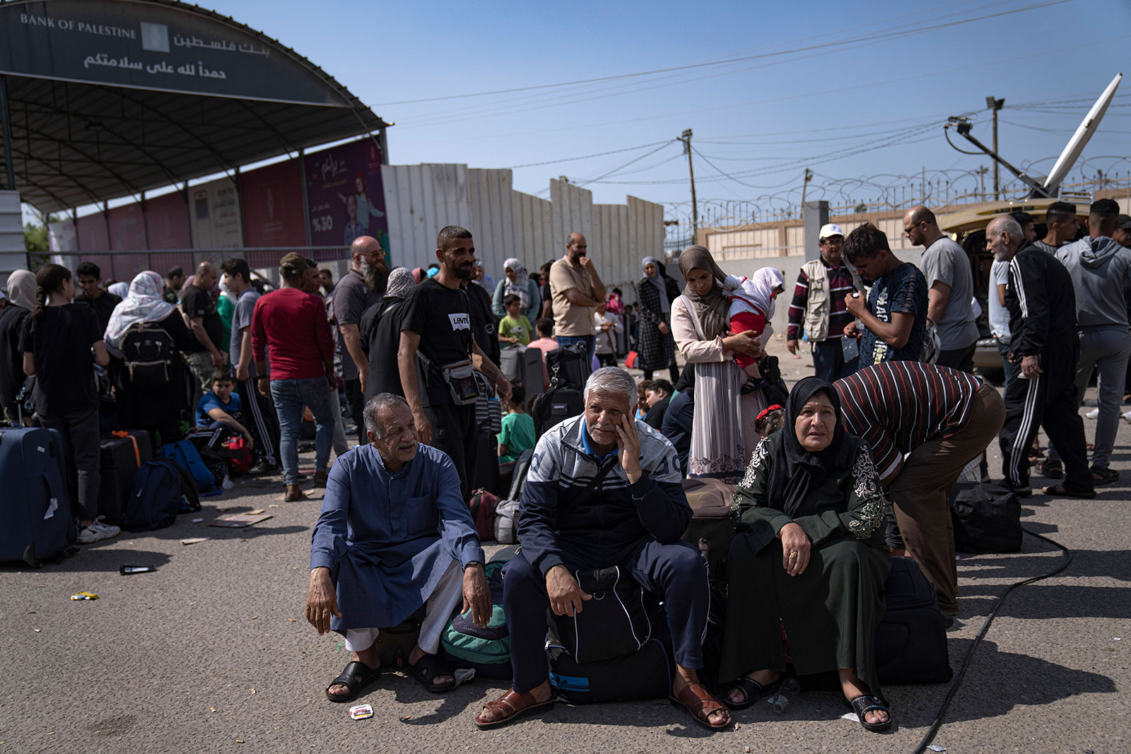 Palestinians wait at the Rafah border crossing in Gaza on Monday, October 16.