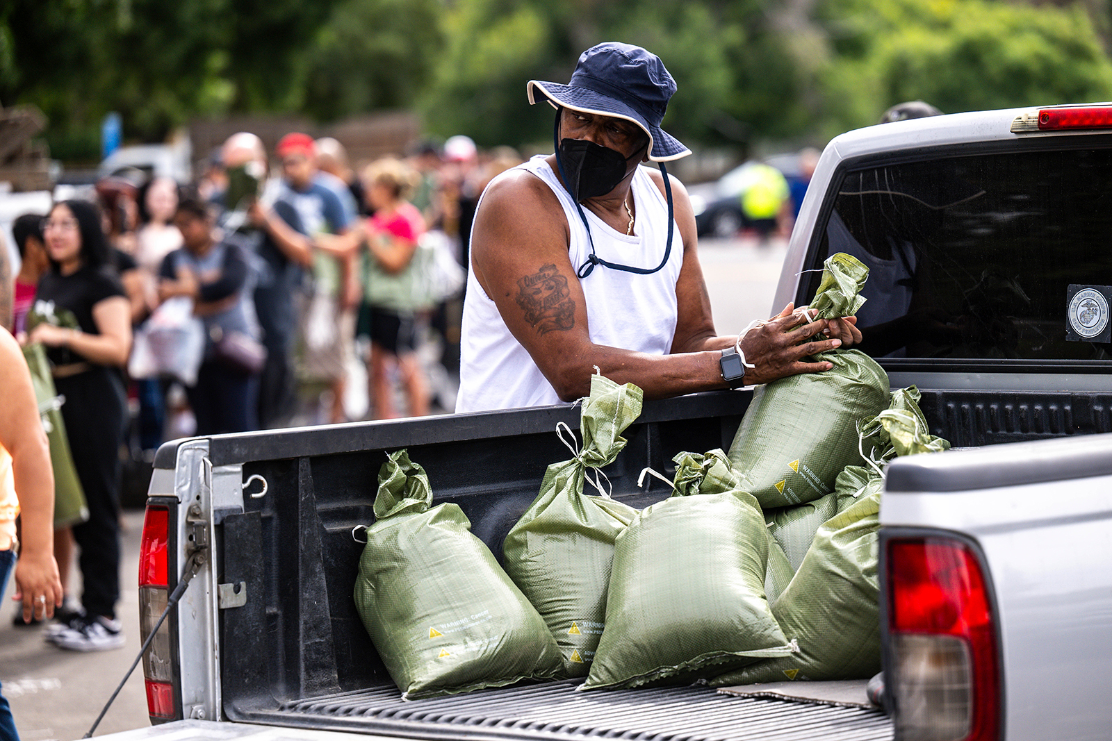 A man loads sandbags onto a truck in preparation for the arrival of Hurricane Hilary in San Bernardino, California on August 19.