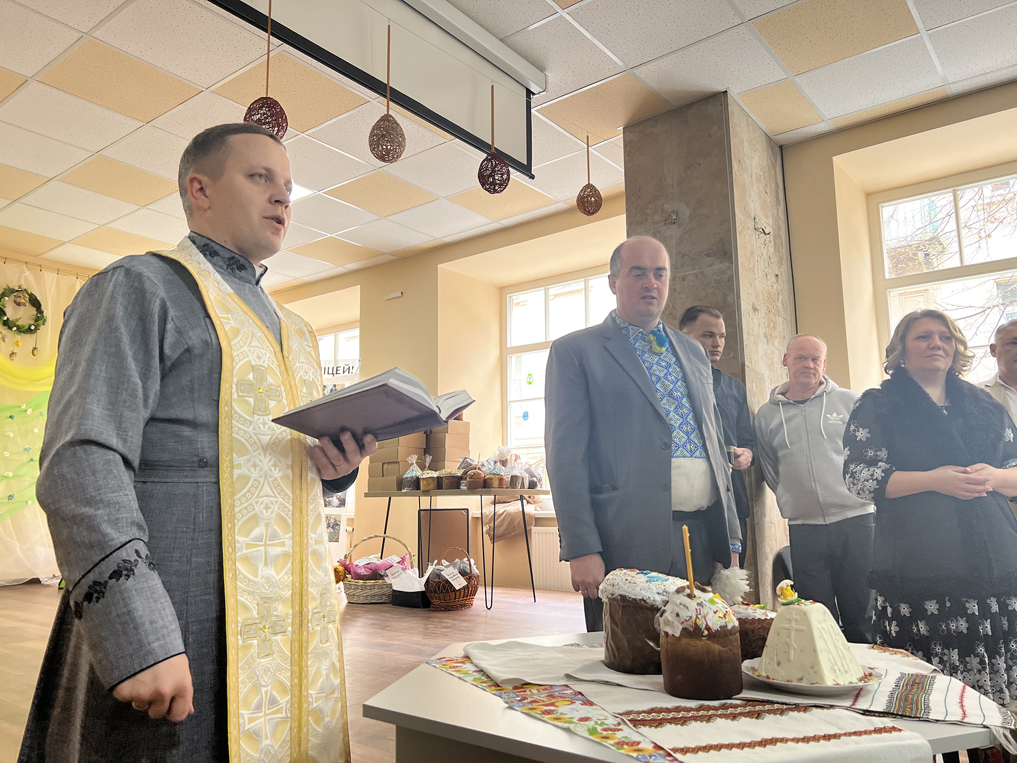 A priest delivers a short prayer before making his way around the room blessing the meal during a special Easter Sunday brunch for displaced Ukrainians in Lviv, Ukraine, on April 24.