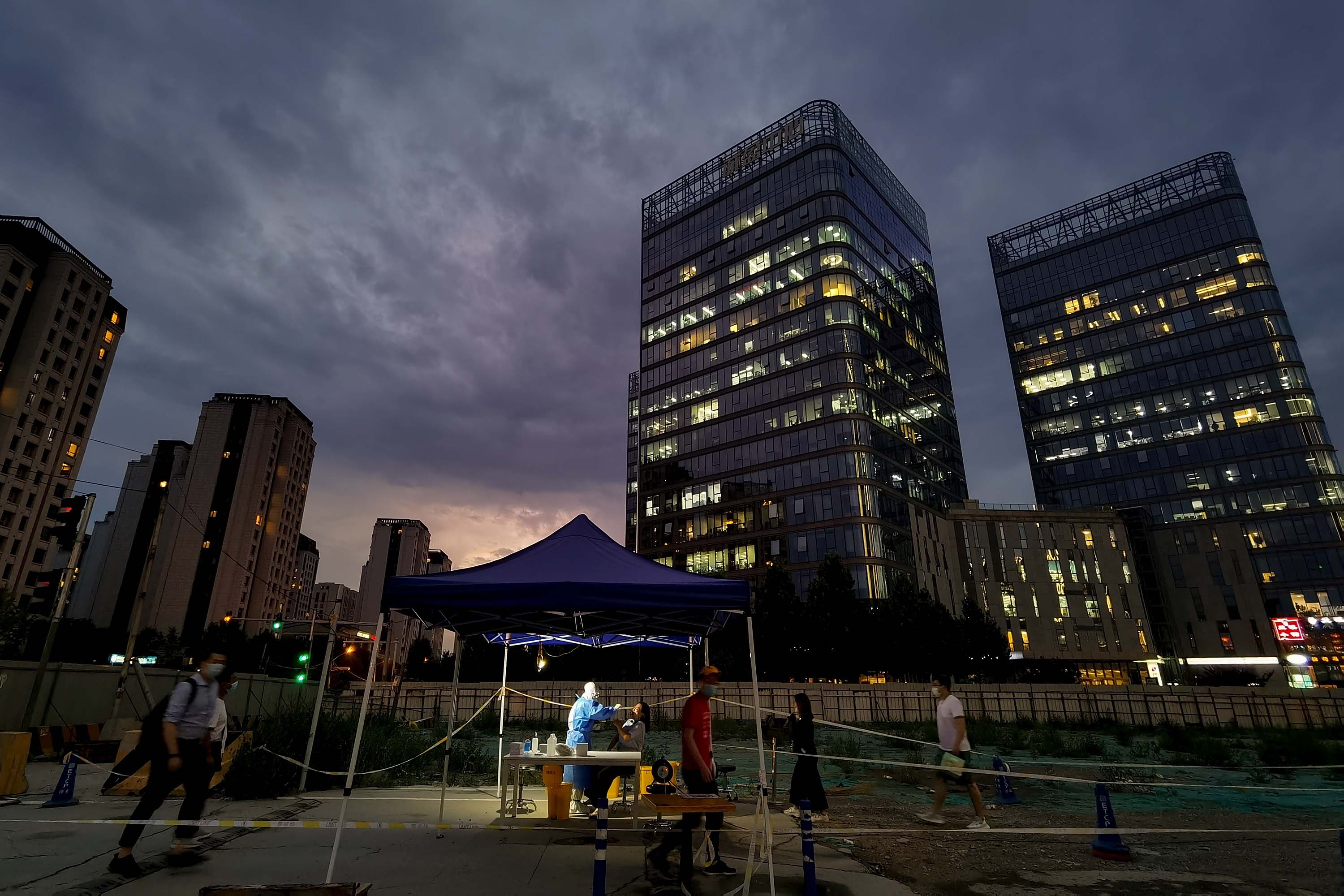 People wait in line at a temporary coronavirus testing station in Beijing, on July 6.