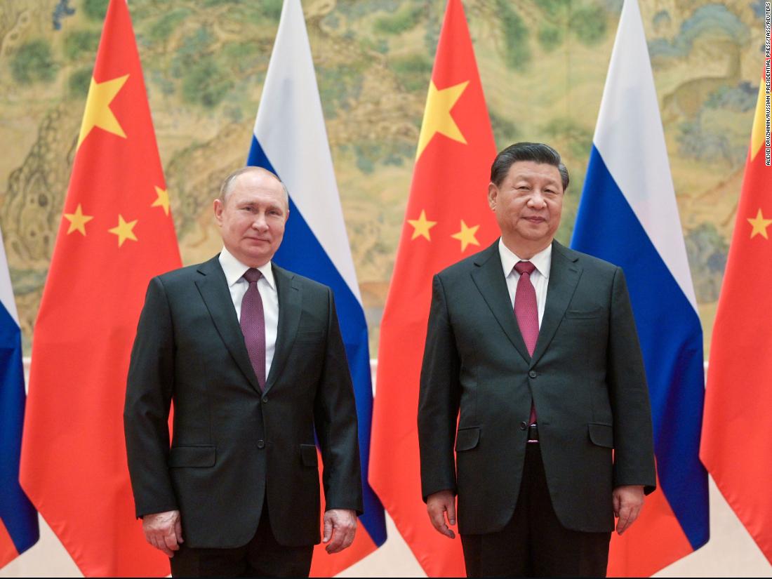 Russian President Vladimir Putin and Chinese President Xi Jinping pose during their meeting in Beijing, on February 4, 2022.