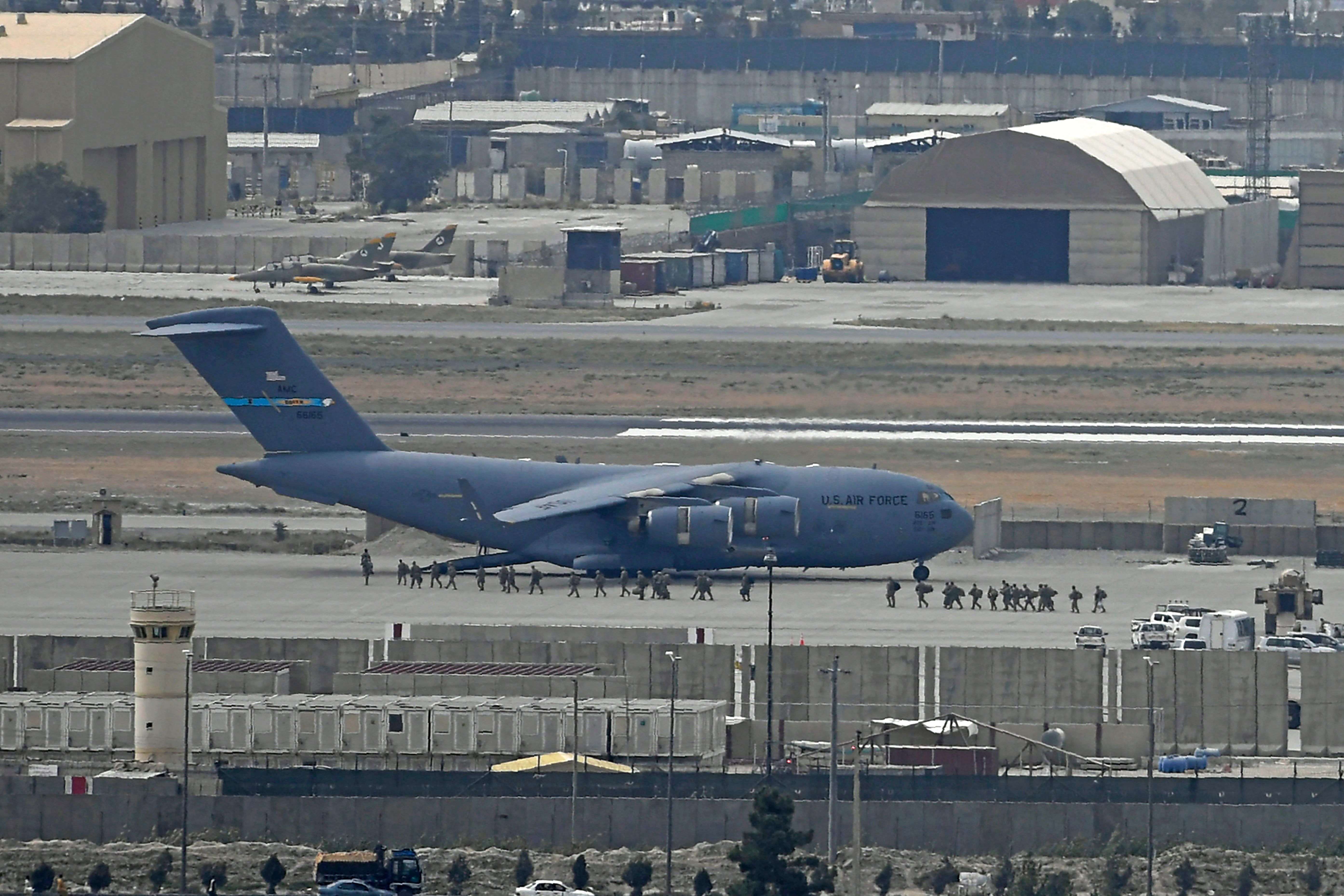 US soldiers board a US Air Force aircraft at the airport in Kabul on August 30, 2021.