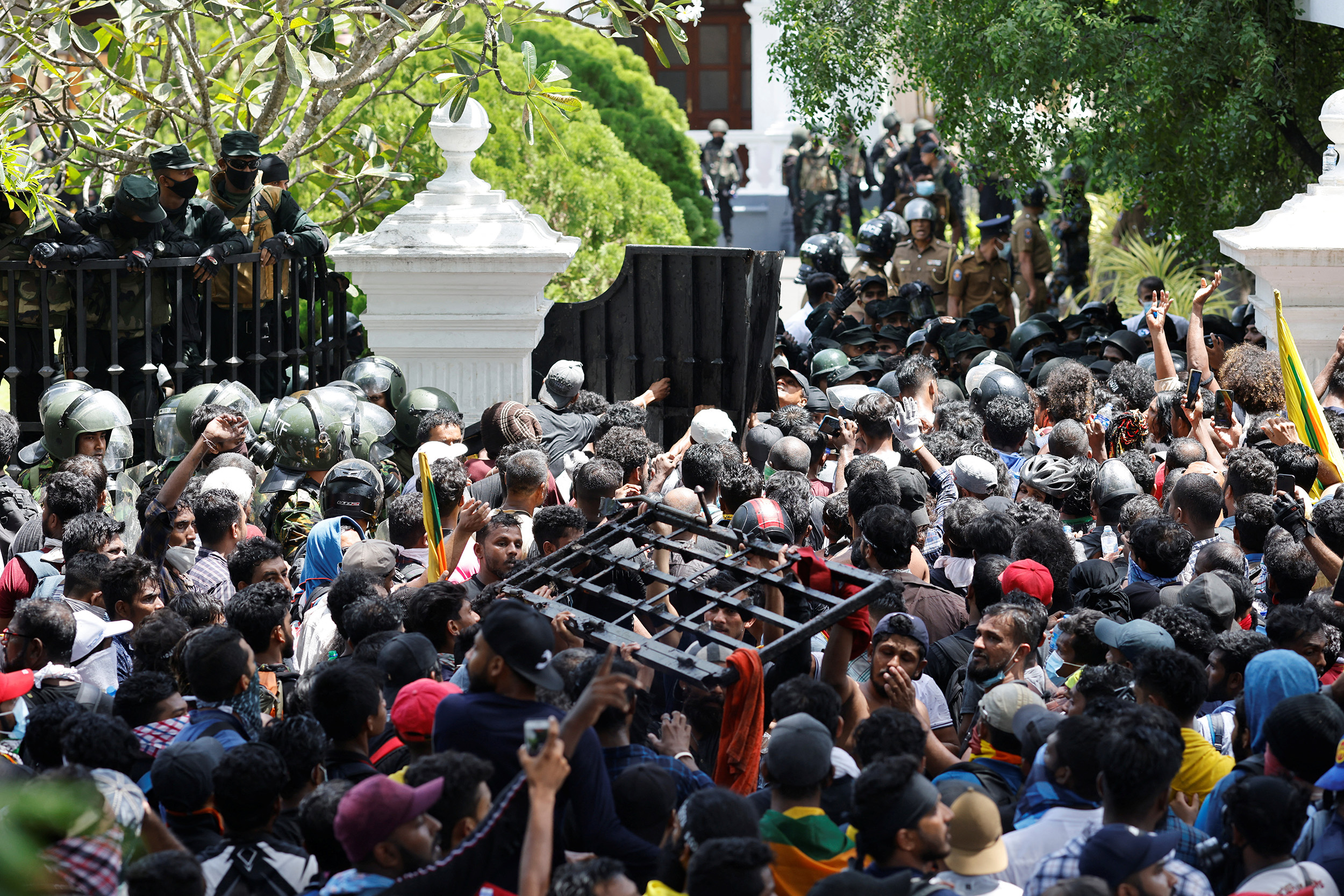 Demonstrators carry the gate to Sri Lanka's Prime Minister Ranil Wickremesinghe's office during a protest in Colombo, Sri Lanka, on July 13.