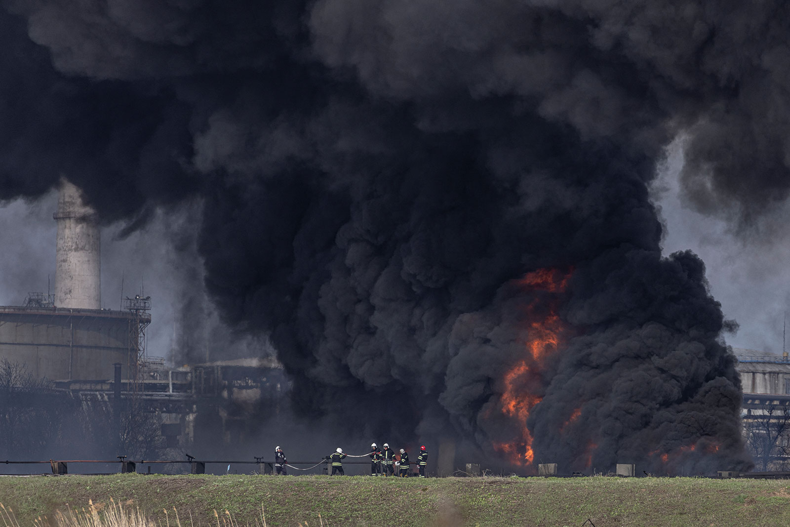 Firefighters work to put out a fire at an oil refinery in Lysychansk after if was hit by a missile in the Luhansk region, Ukraine, on Saturday, April 16. 