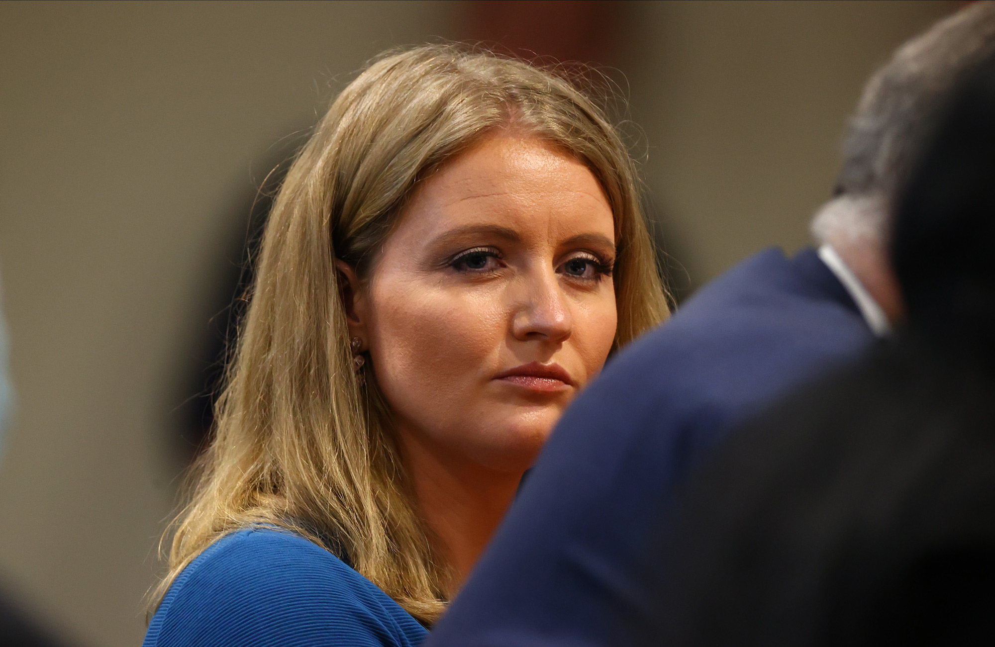 Jenna Ellis, a member of President Donald Trump's legal team, listens to a Detroit poll worker during a Michigan House Oversight Committee on December 2 in Lansing, Michigan. 