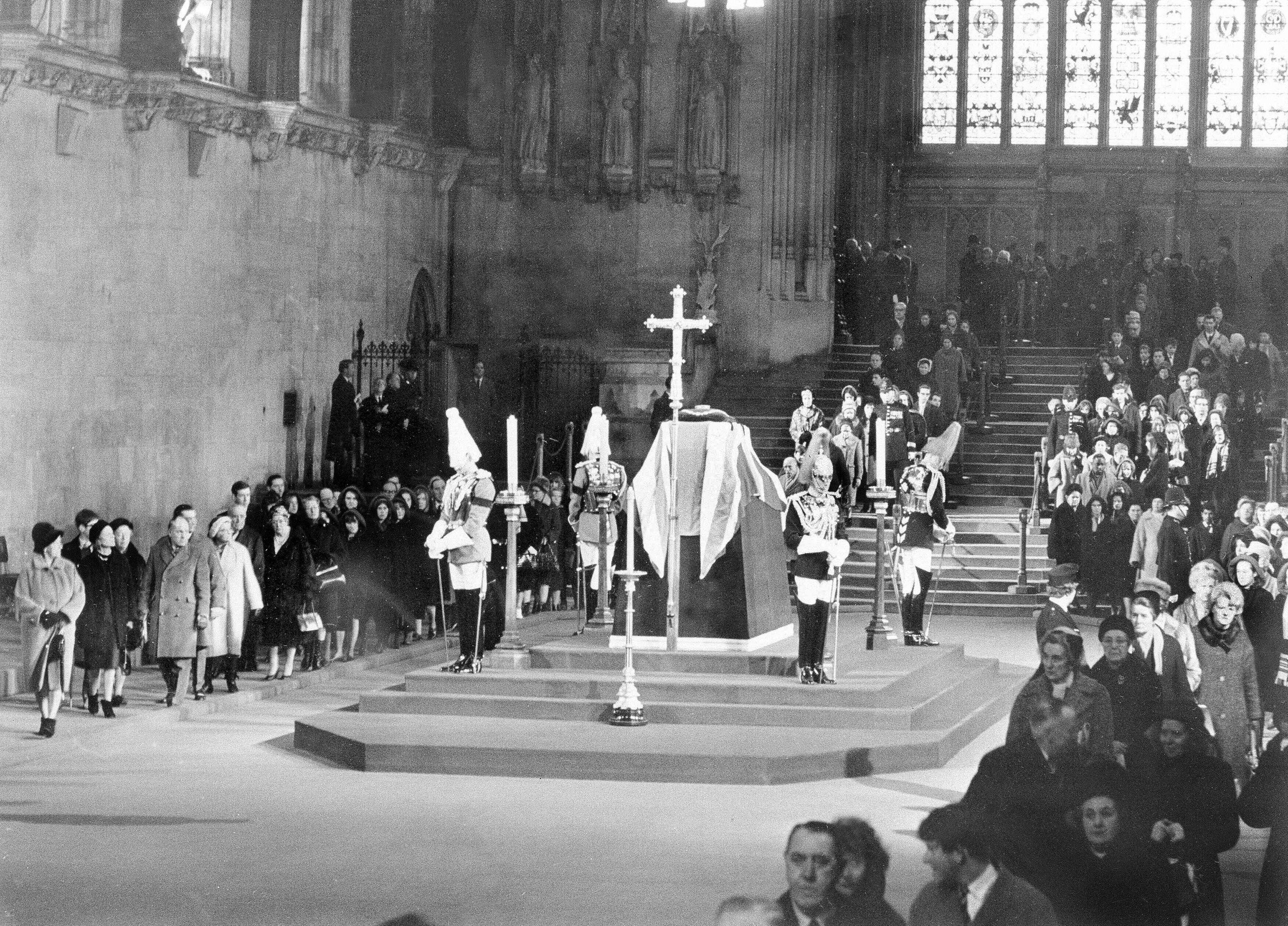 Two lines of mourners file past the coffin of Winston Churchill in Westminster Hall in January 1965.