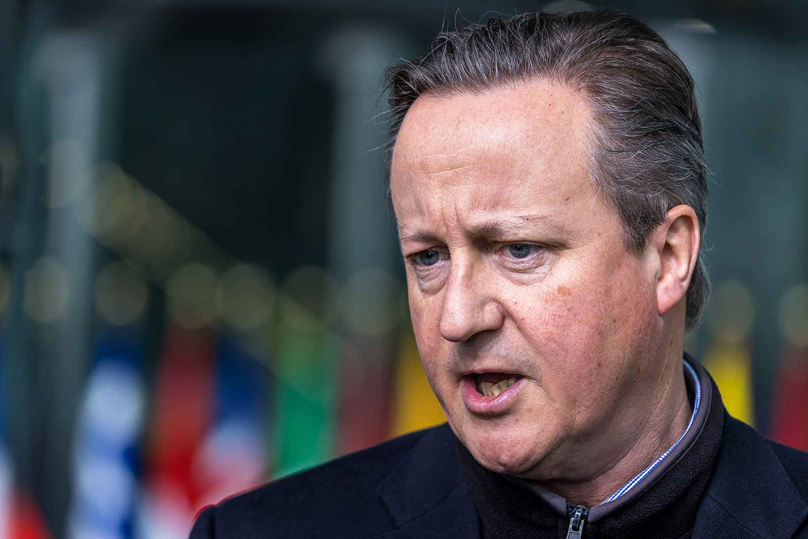 British Foreign Secretary David Cameron speaks to members of the press at NATO headquarters in Brussels, Belgium, on April 3. 