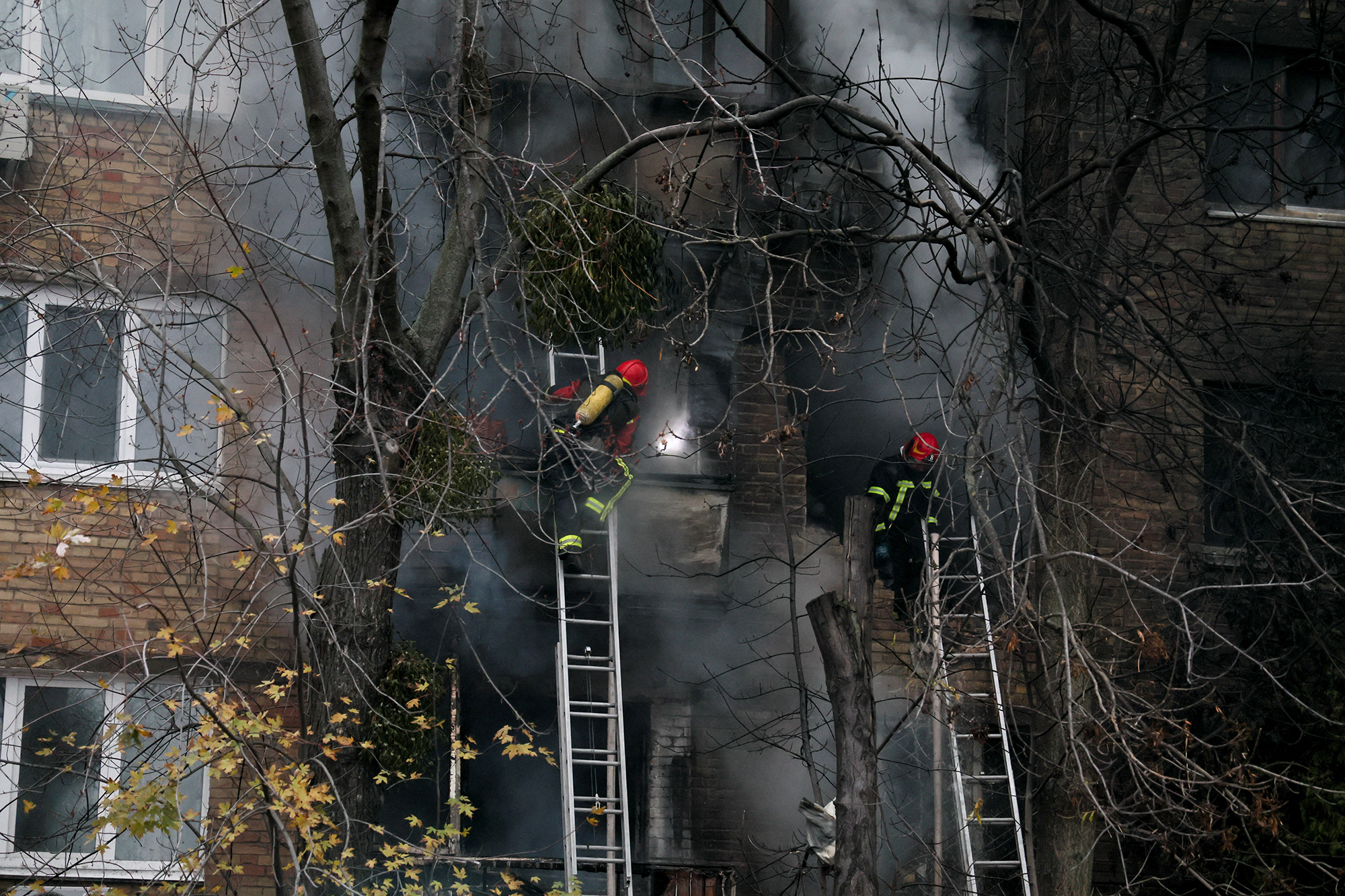 Firefighters work to put out a fire in a residential building hit by a Russian strike in Kyiv, Ukraine, on November 15.