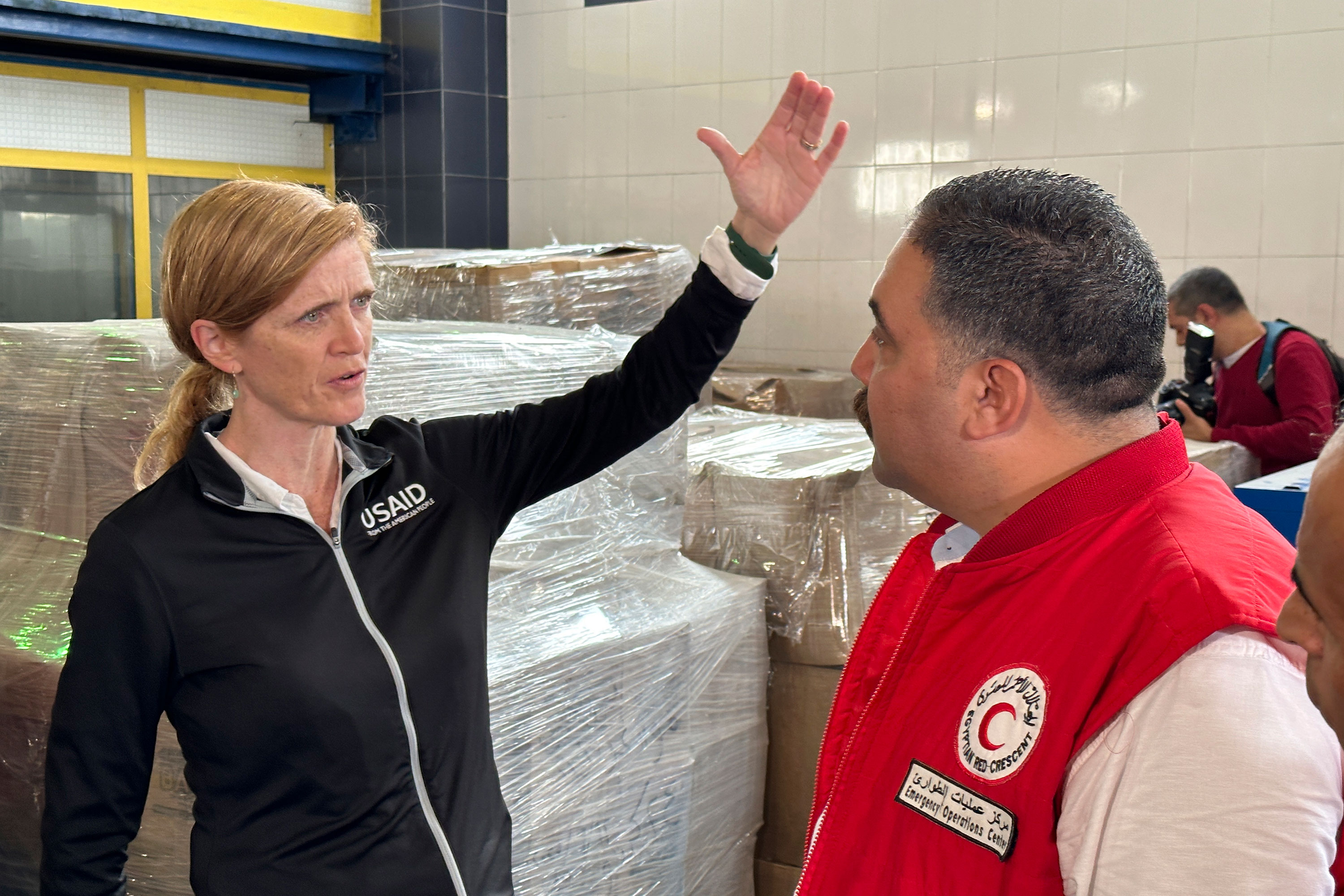 US Aid Administrator Samantha Power speaks to an Egyptian Red Crescent official as she arrives at the international humanitarian assistance hub in Al-Arish, Egypt, on Tuesday.