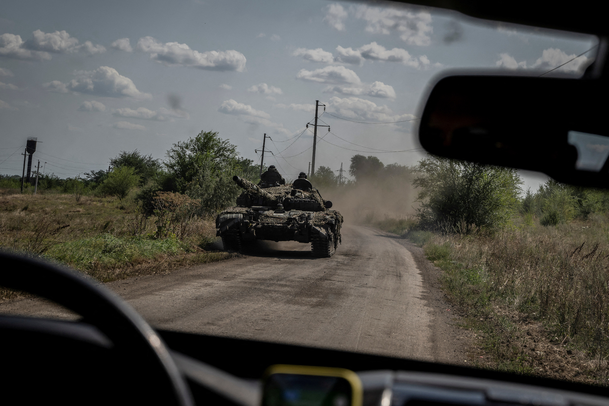 Ukrainian troops ride a tank near the village of Robotyne.