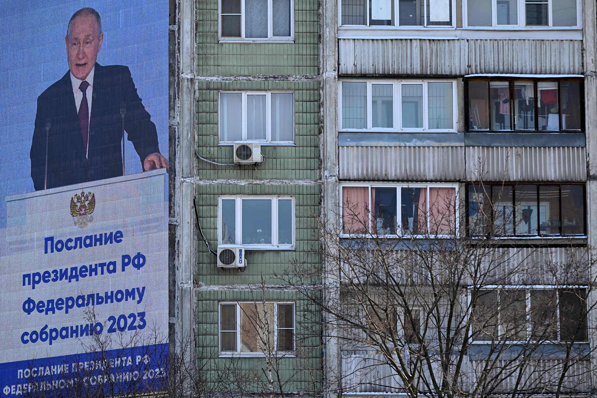 Russian President Vladimir Putin is seen on an outdoor screen on the facade of a building delivering his annual state of the nation address in Moscow, Russia, on February 21.