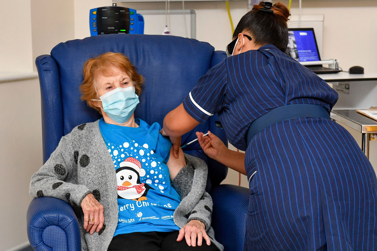 Margaret Keenan, the first patient in the UK to receive the Pfizer-BioNTech Covid-19 vaccine, receives a shot at University Hospital in Coventry, England on Dec. 8. 