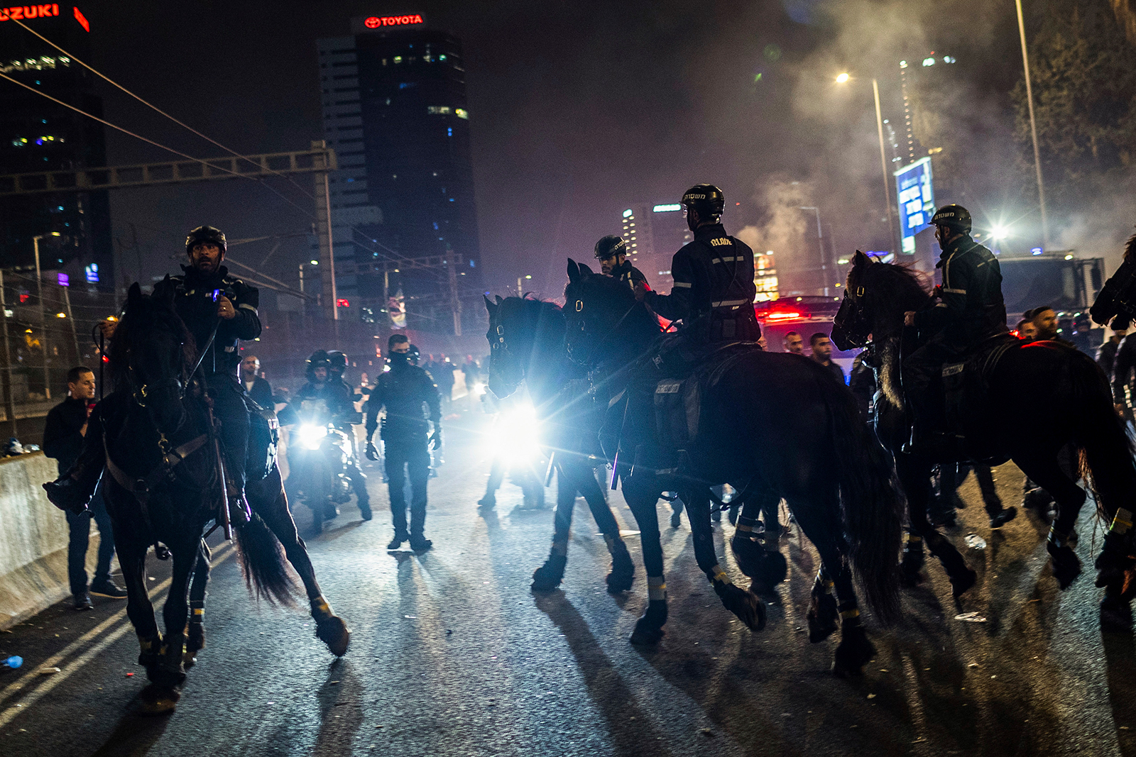Israeli mounted police disperse anti-government protesters in Tel Aviv, on Monday.