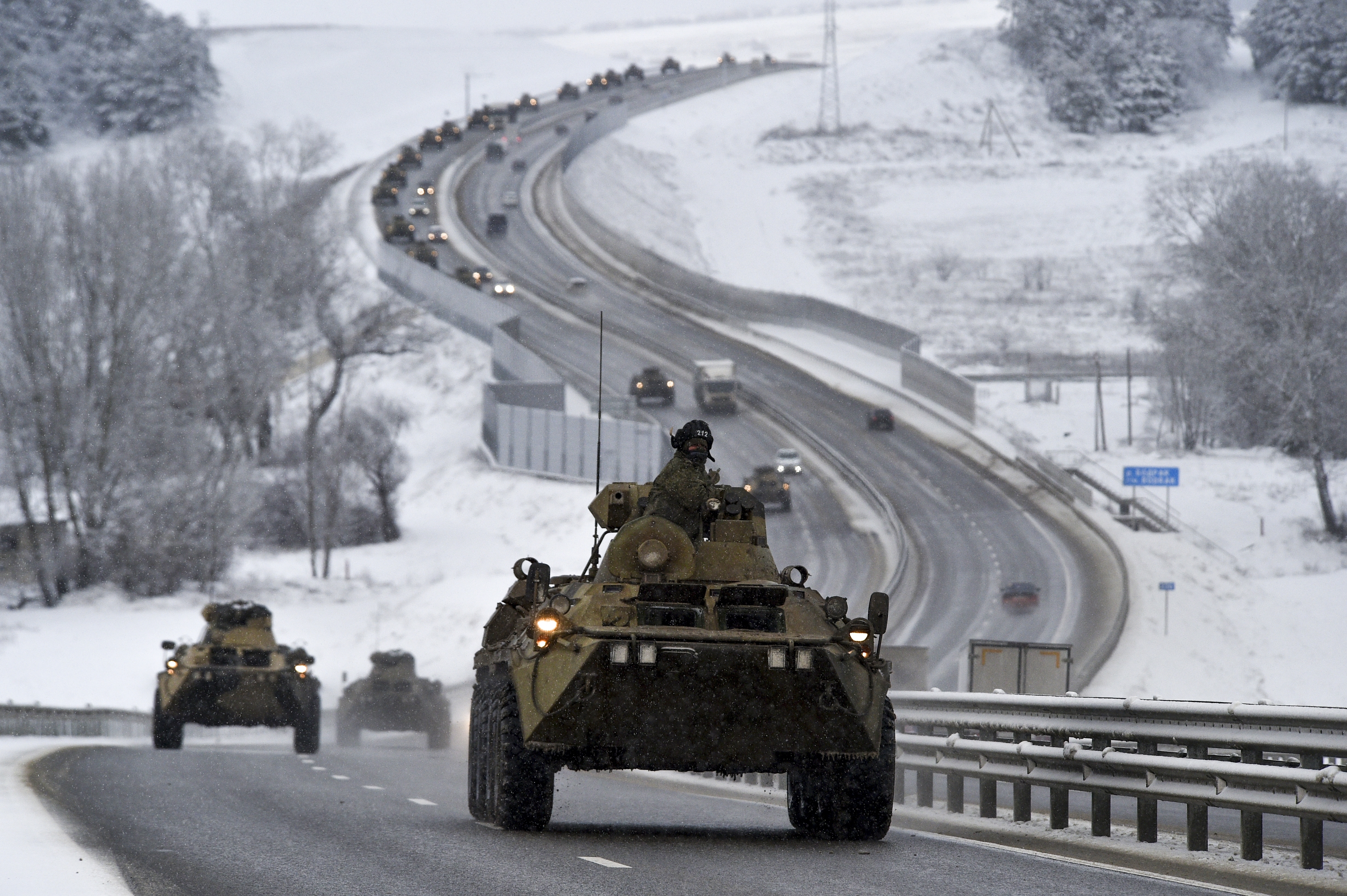 A convoy of Russian armored vehicles moves along a highway in Crimea on Tuesday, January 18. Russia has massed an estimated 100,000 troops with tanks and other heavy weapons near Ukraine in what the West fears. Fear can be a prelude to an invasion. 