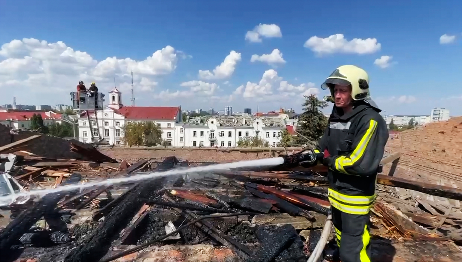 In this screengrab taken from video provided by the Ukrainian Emergency Service, firefighters work on the roof of a theater damaged by a Russian missile attack in Chernihiv, Ukraine, on August 19. 