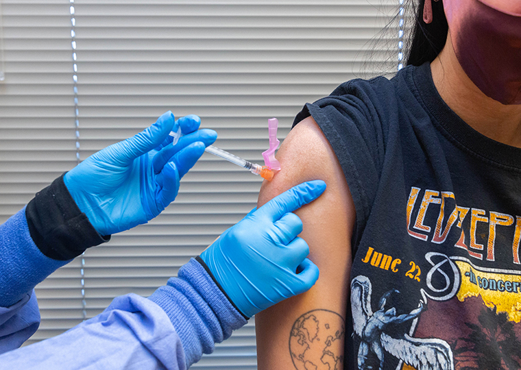 A healthcare worker administers a dose of the Pfizer-BioNTech Covid-19 vaccine to a resident at the Jordan Valley Community Health Center in Springfield, Missouri, on June 29.