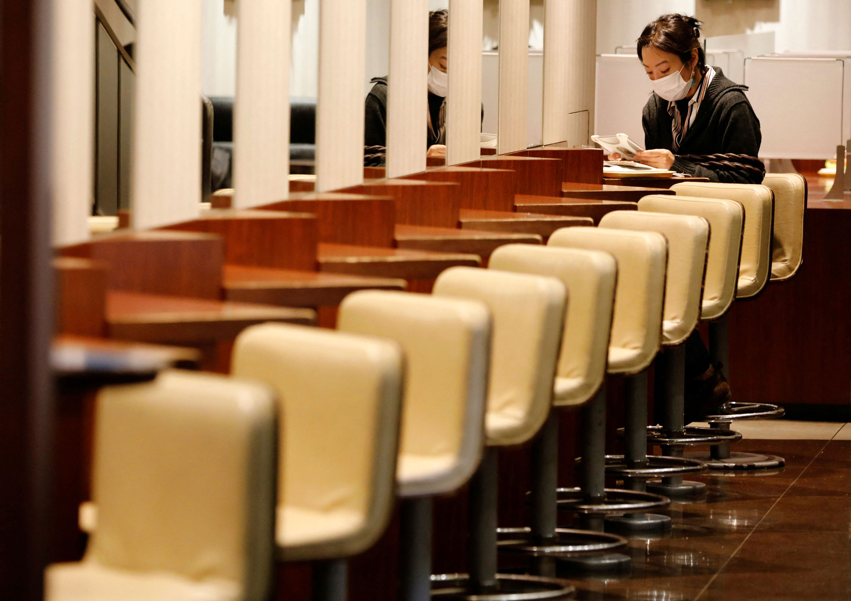 A woman sits in a coffee shop in Tokyo, Japan, January 11.