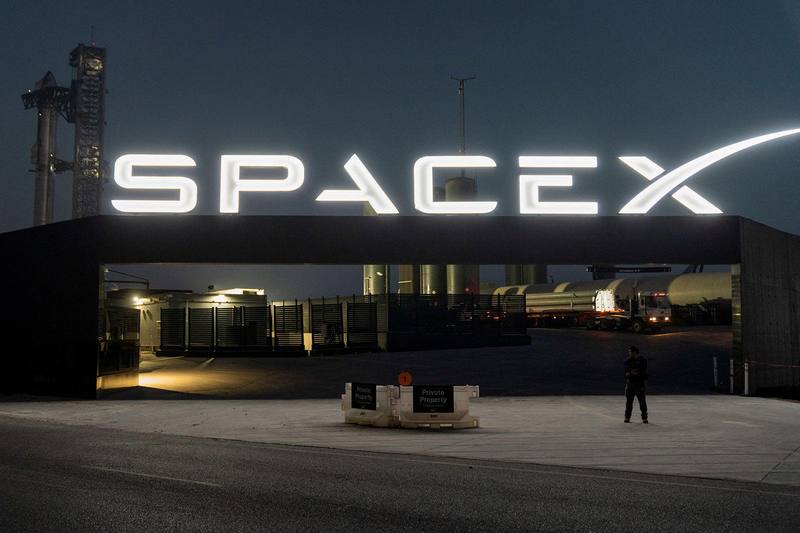 A security guard monitors the entrance as SpaceX's next-generation Starship spacecraft atop its powerful Super Heavy rocket is prepared for a third launch from the company's Boca Chica launchpad on an uncrewed test flight, near Brownsville, Texas, U.S. on March 13.