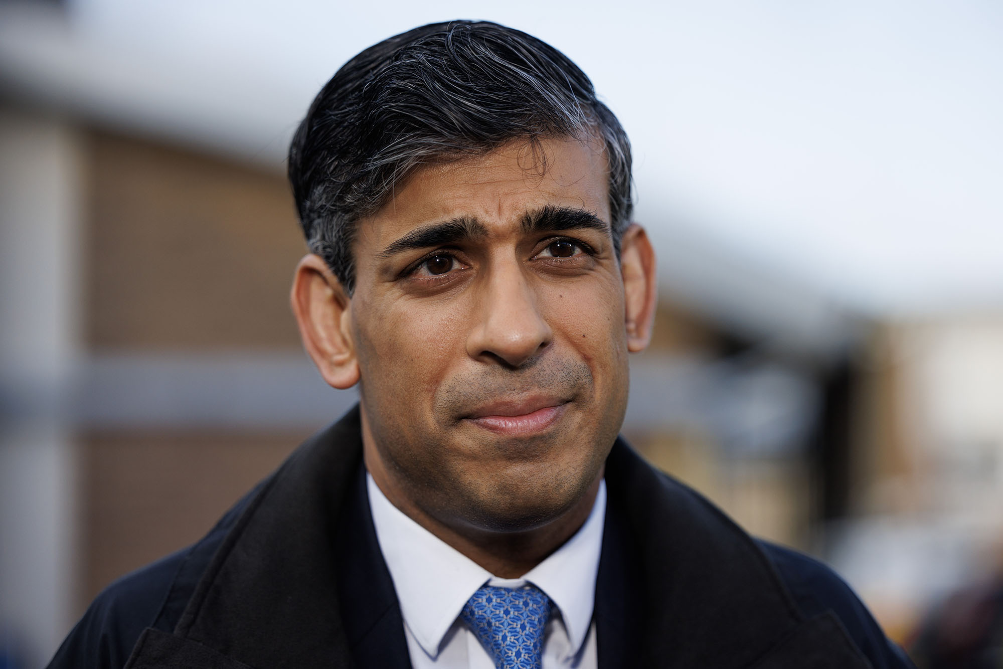 British Prime Minister Rishi Sunak looks on during a media visit to Harlow Police Station on February 16.