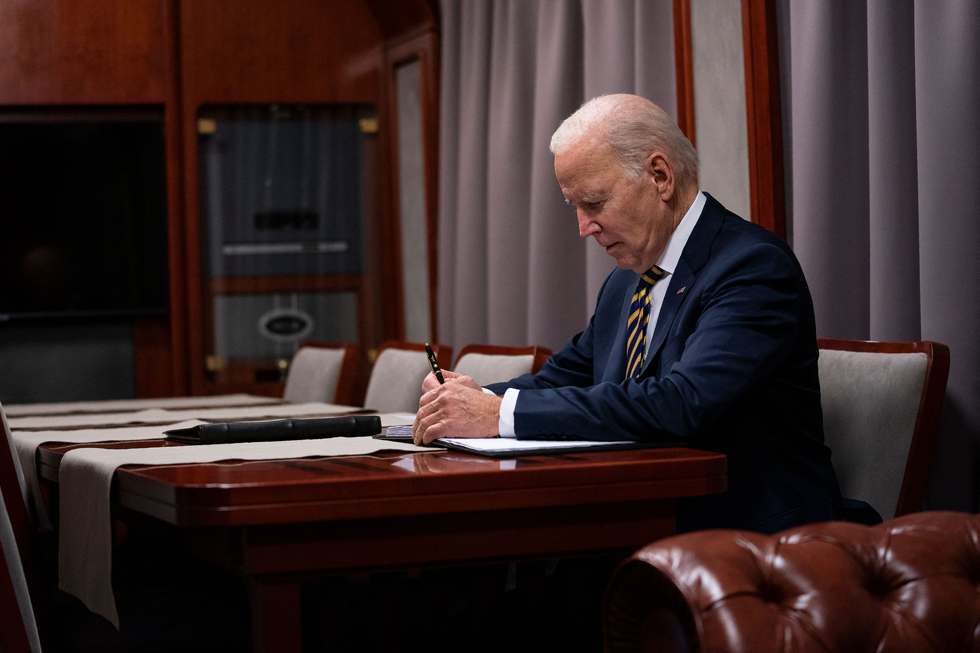 US President Joe Biden sits on a train as he goes over his speech after a surprise visit to meet with Ukrainian President Volodymyr Zelensky, in Kyiv, Ukraine, on February 20.