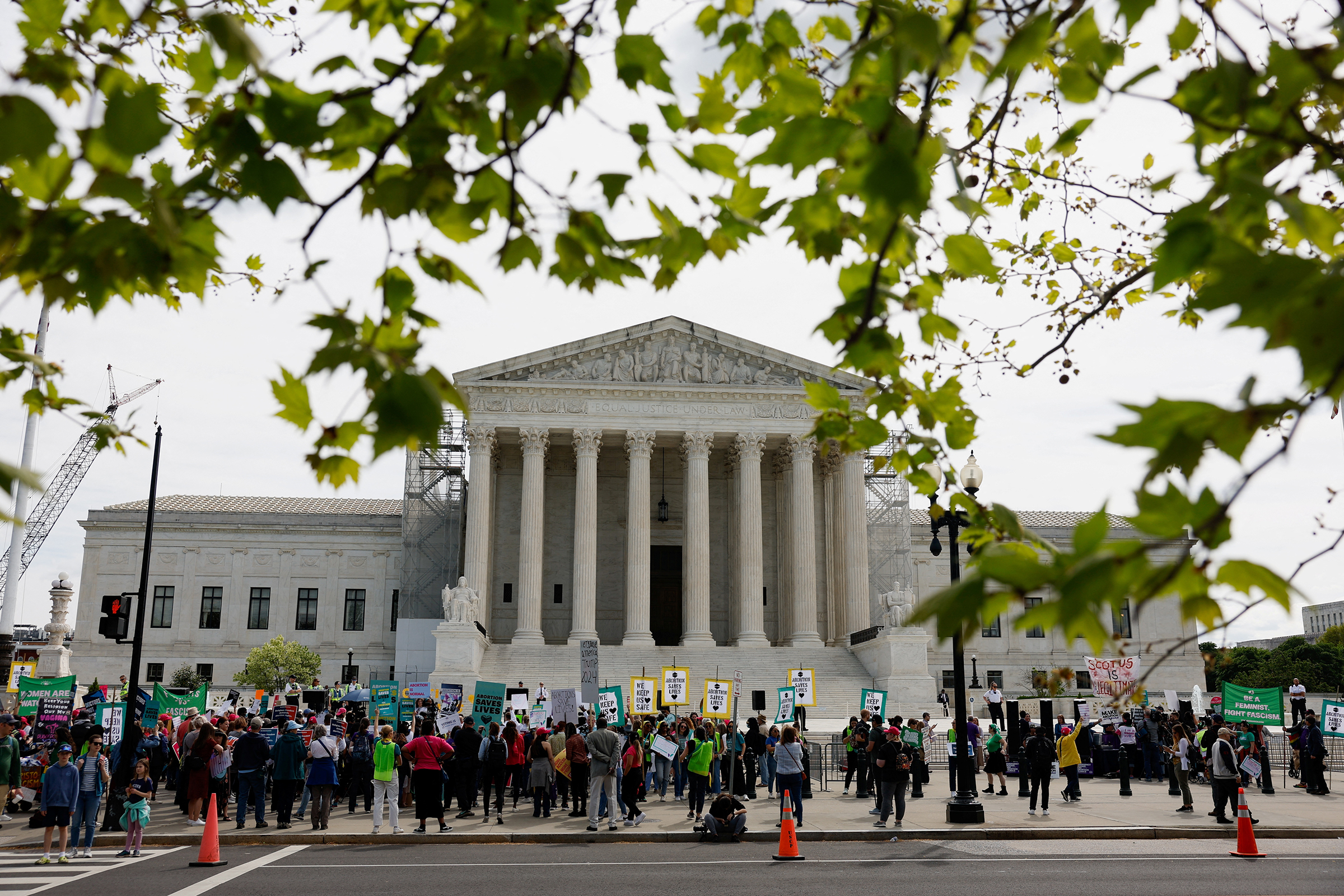 People gather during a protest in support of reproductive rights and emergency abortion care on the day the Supreme Court justices hear oral arguments over the legality of Idaho's Republican-backed, near-total abortion ban in medical-emergency situations, in Washington, DC, on April 24.
