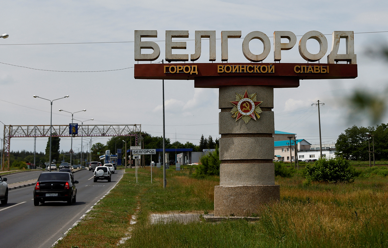 Cars drive past a stele displaying the city name in Belgorod, Russia, on June 8.