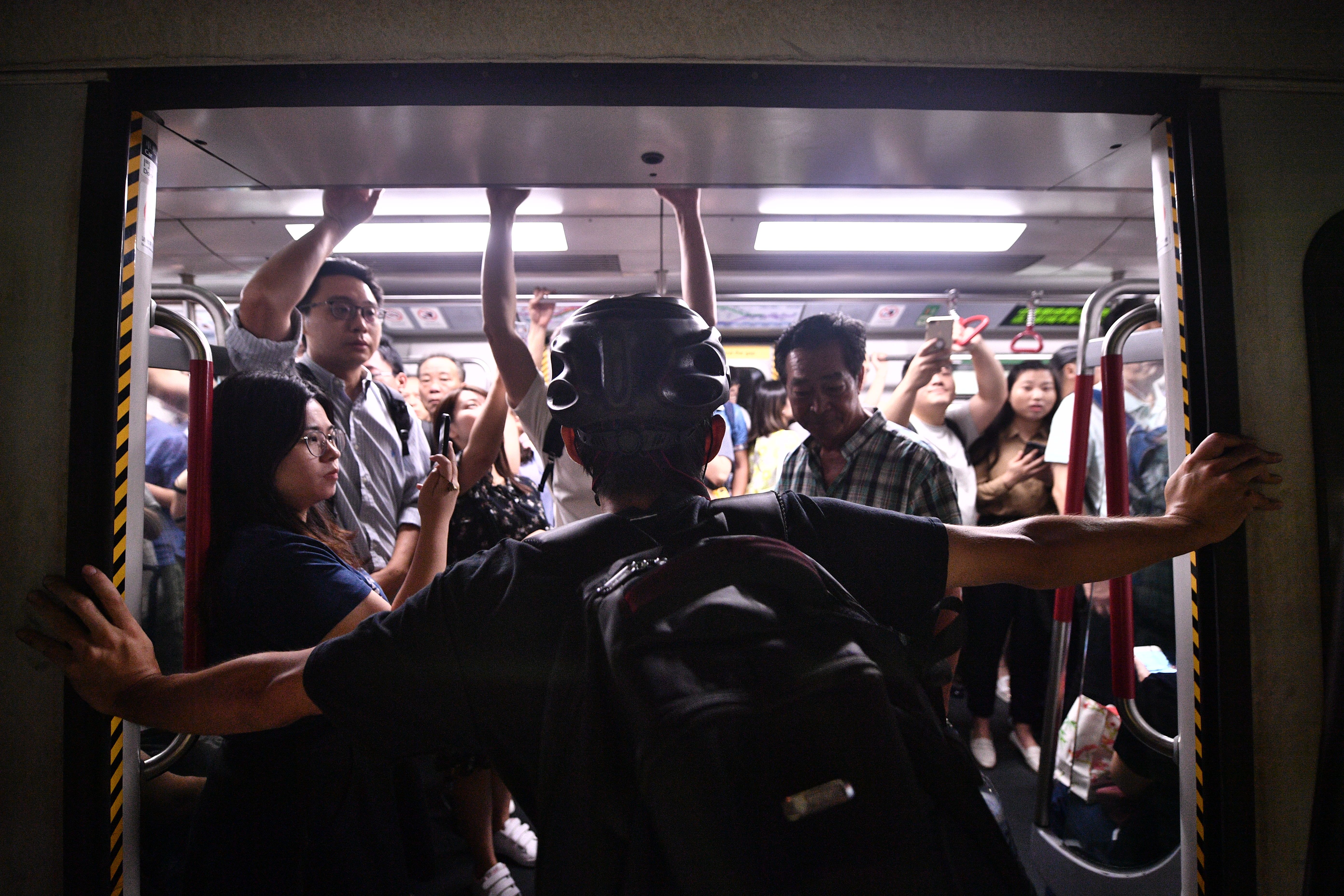 Protesters blocking the train doors at Fortress Hill station in Hong Kong on August 5, 2019.