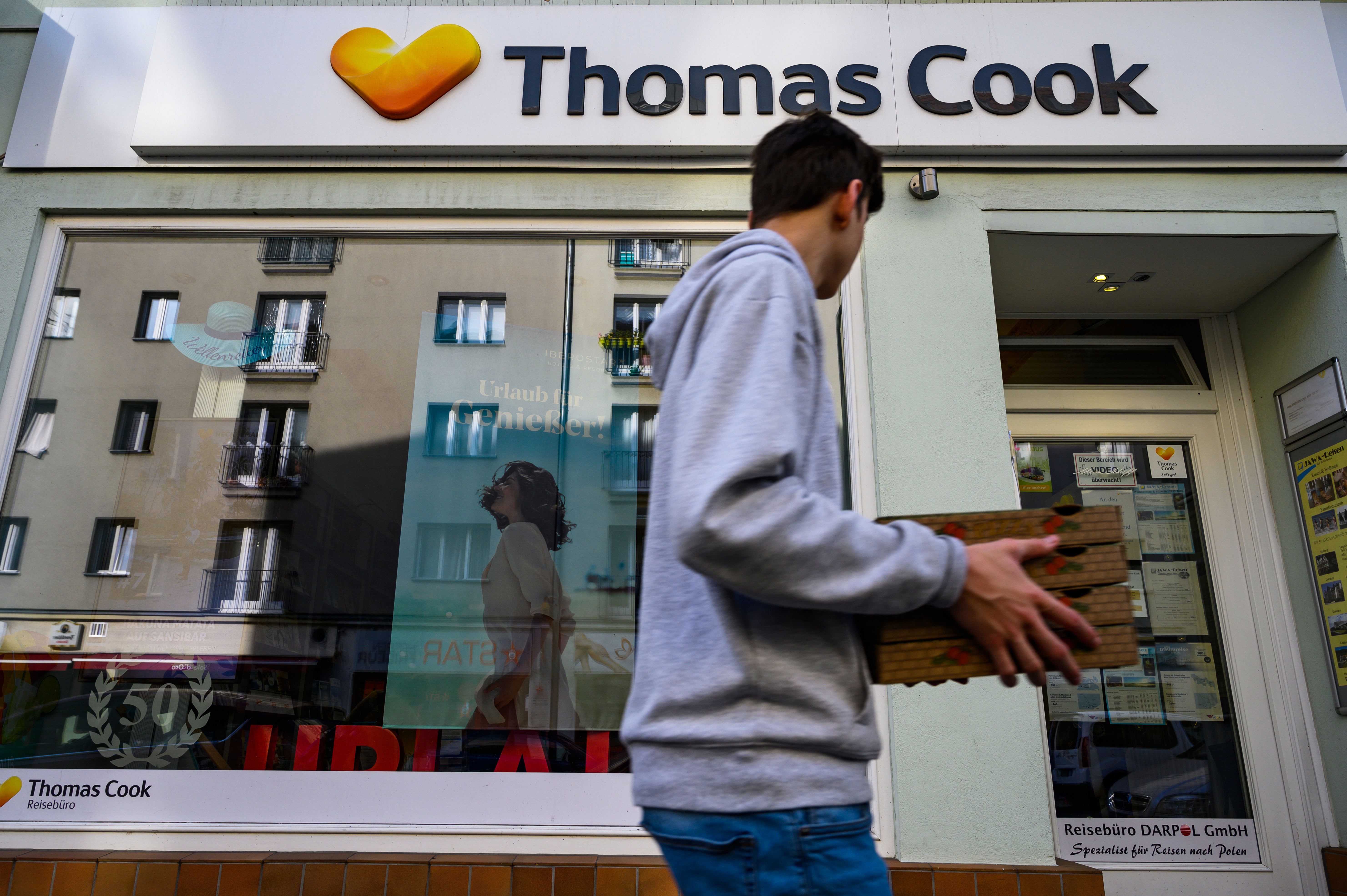 A man passes a travel agency run by British tour operator Thomas Cook in Berlin on September 23, 2019, as the company declared bankruptcy, stranding 600,000 tourists.