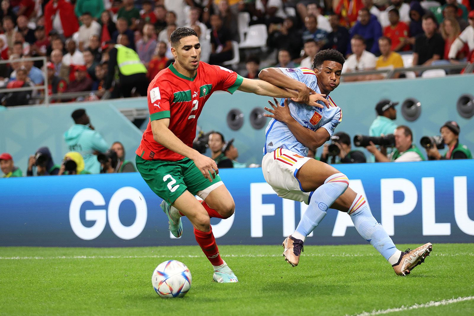 Morocco’s Achraf Hakimi battles for possession with Spain’s Alejandro Balde.