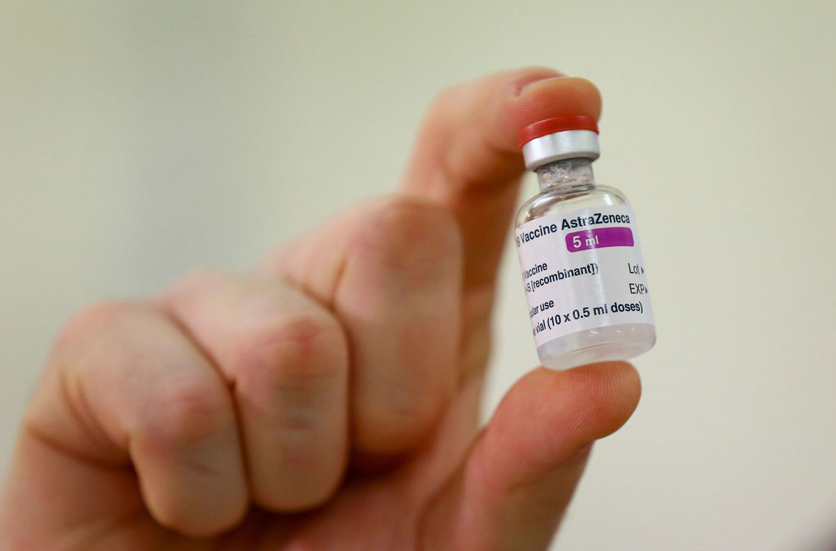 A vial of the Covid-19 vaccine developed by Oxford University and AstraZeneca is checked as doses arrive at the Princess Royal Hospital in Haywards Heath, England on January 2.