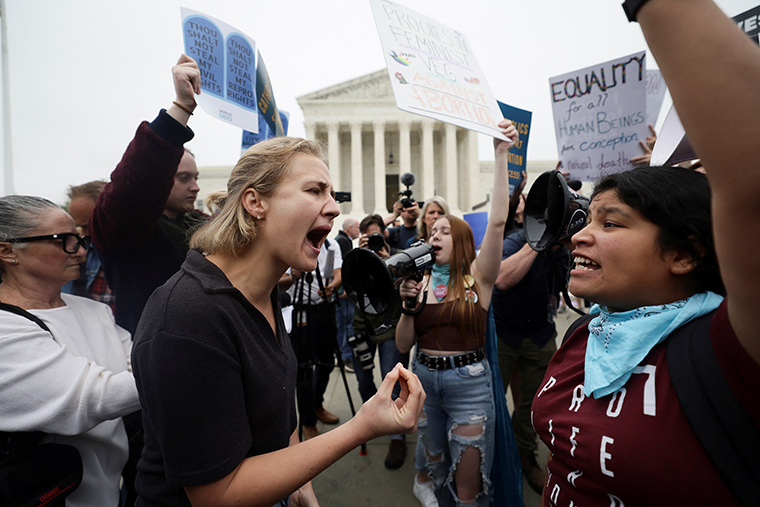 Pro-abortion and anti-abortion demonstrators confront each other outside the U.S. Supreme Court.