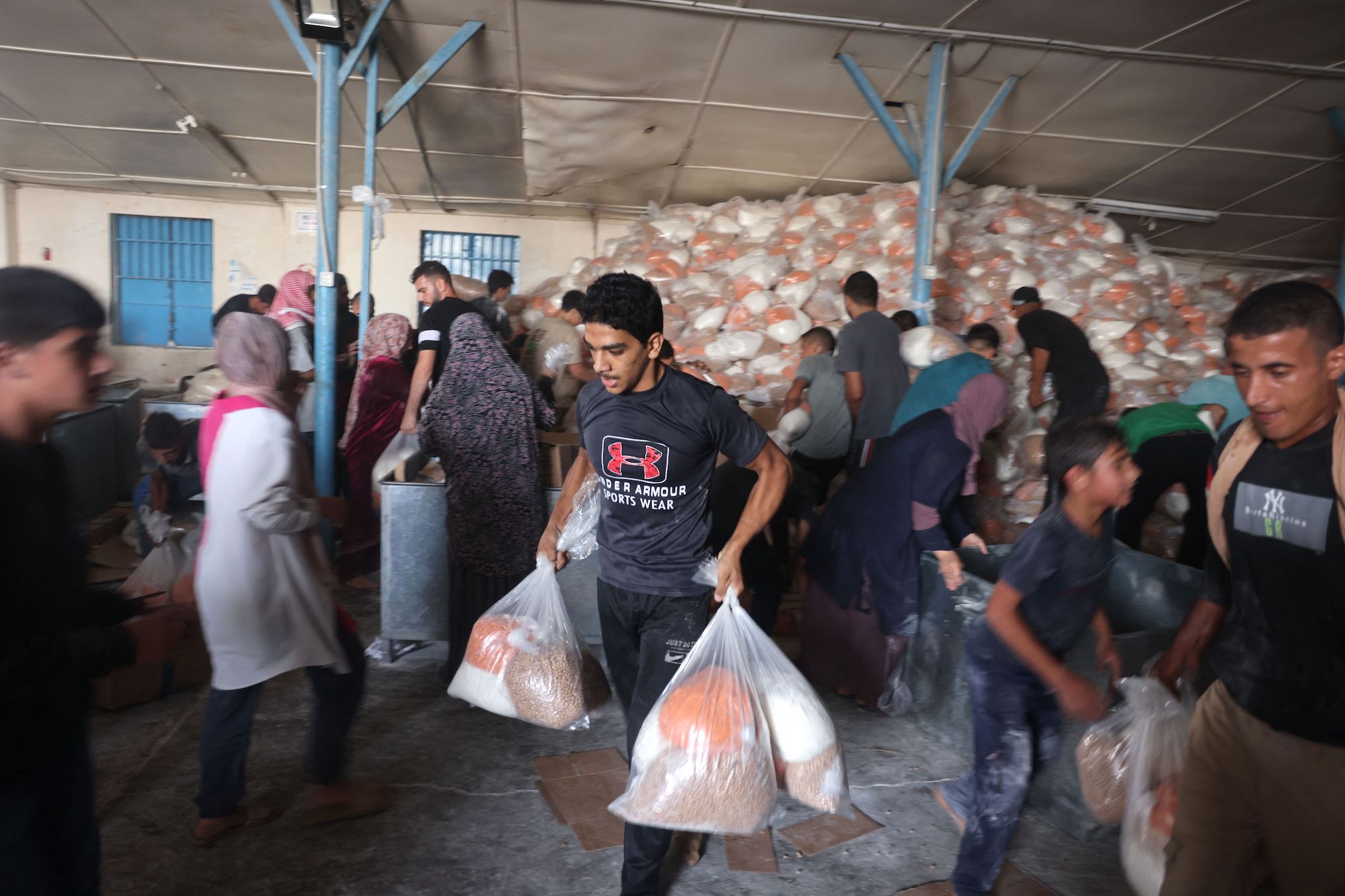 Palestinians storm a UN-run aid supply center in Deir al-Balah on Saturday.