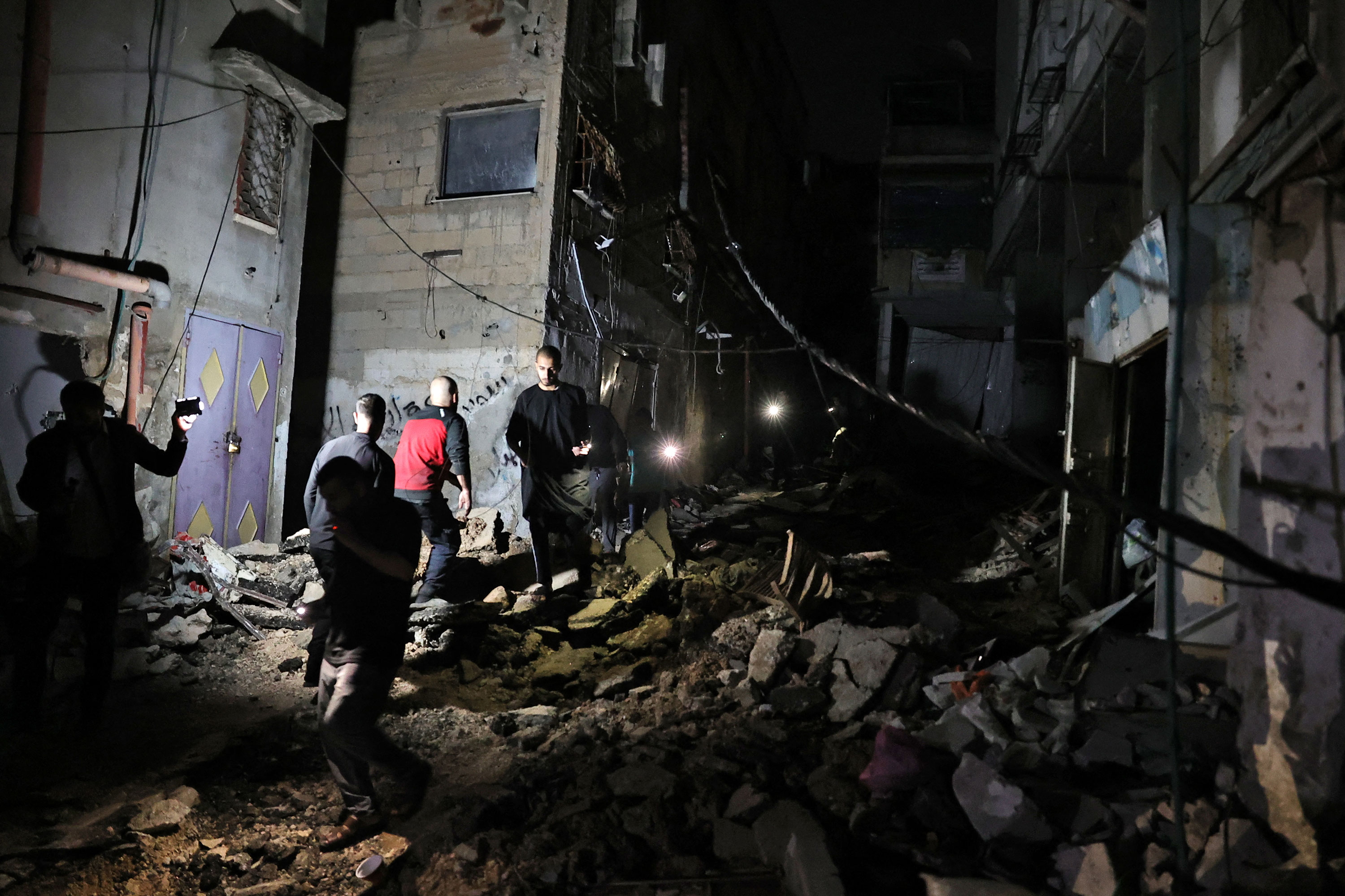 Palestinians inspect the damage left by an Israeli operation at the Nur al-Shams refugee camp near Tulkarm in the occupied West Bank on Saturday. 