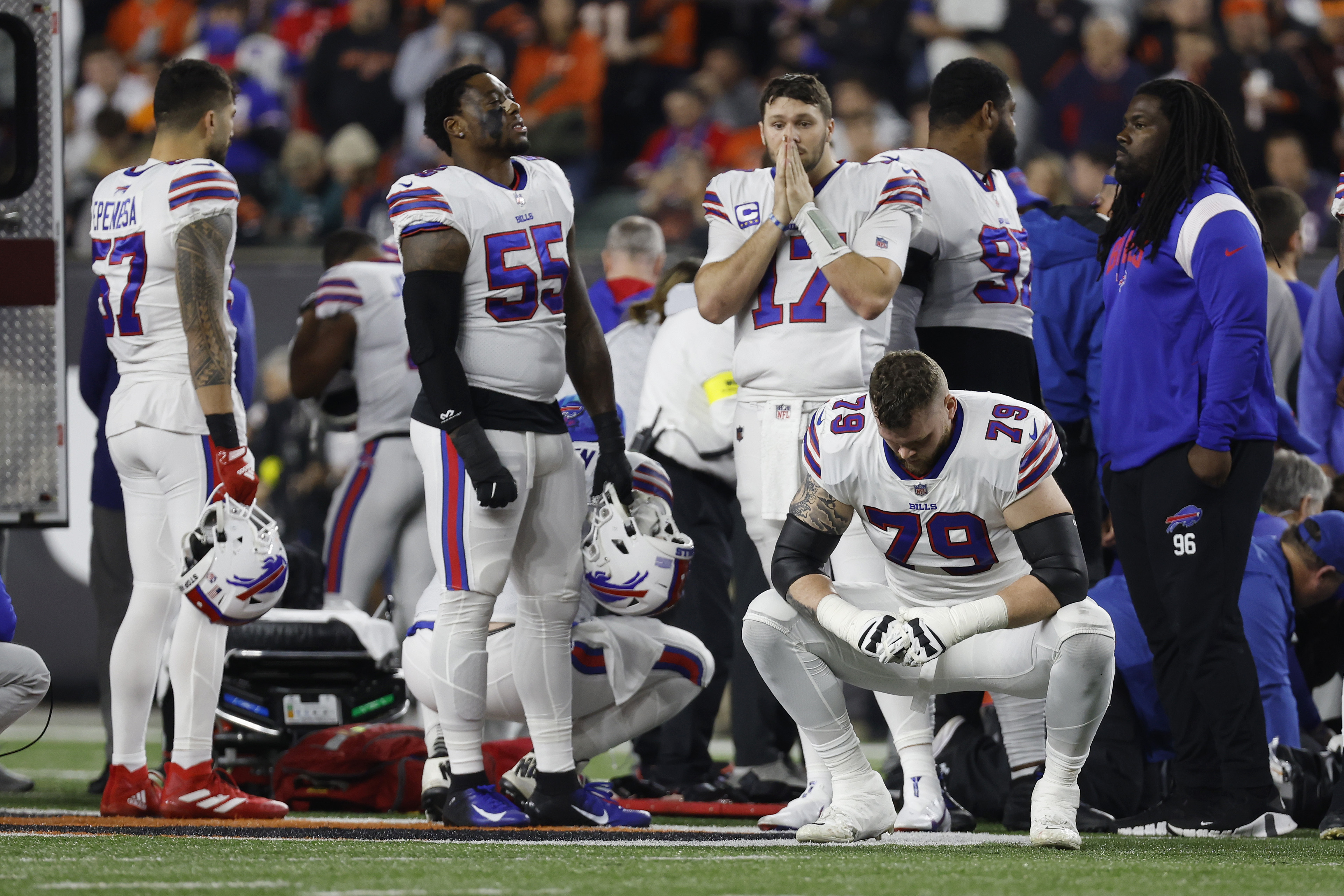 Buffalo Bills players react after teammate Damar Hamlin was injured during a game against the Bengals at Paycor Stadium on Monday in Cincinnati, Ohio.