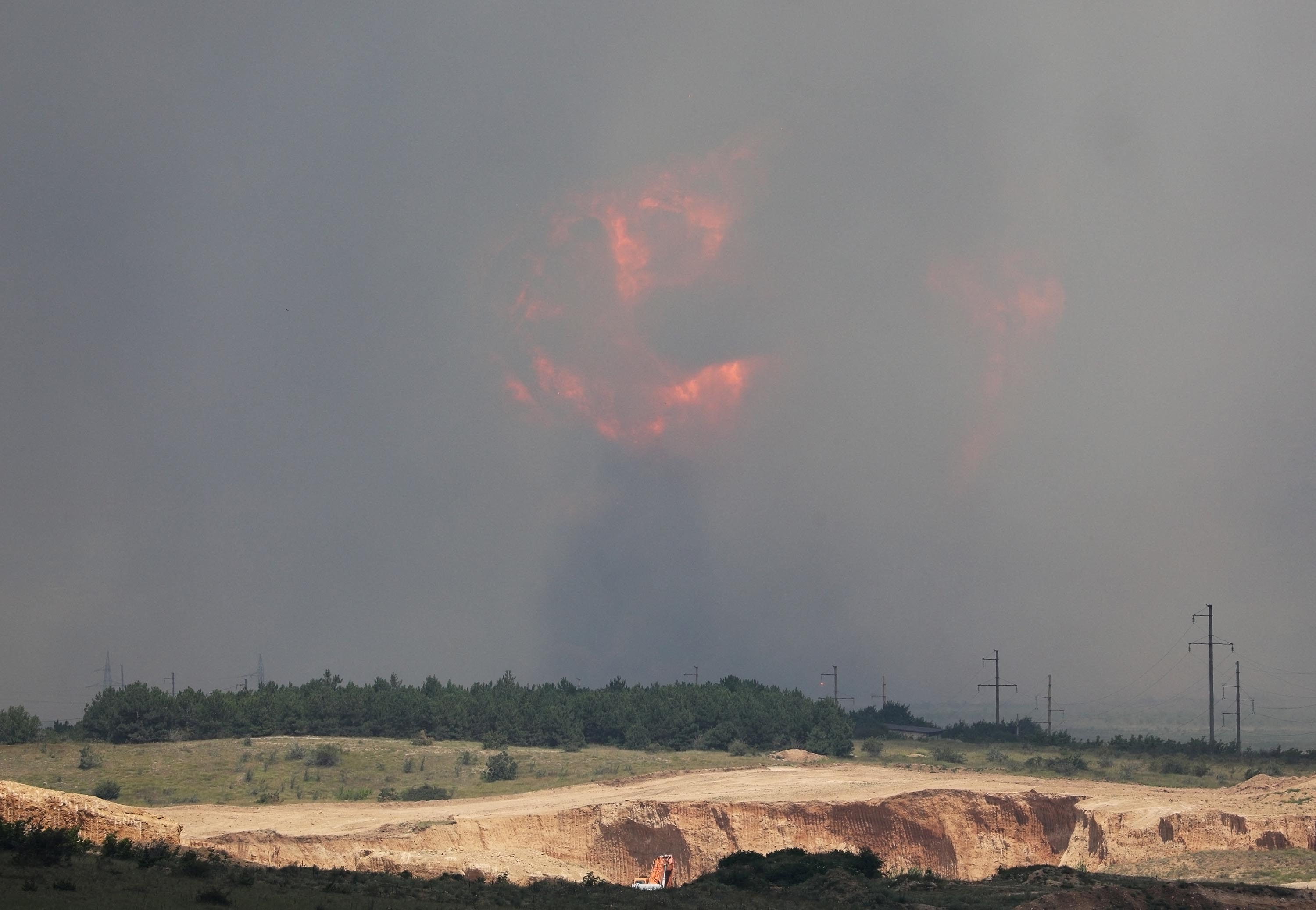 Smoke and flames rise from an explosion during a fire at a military training ground in Crimea’s Kirovsky district, on Wednesday, July 19.