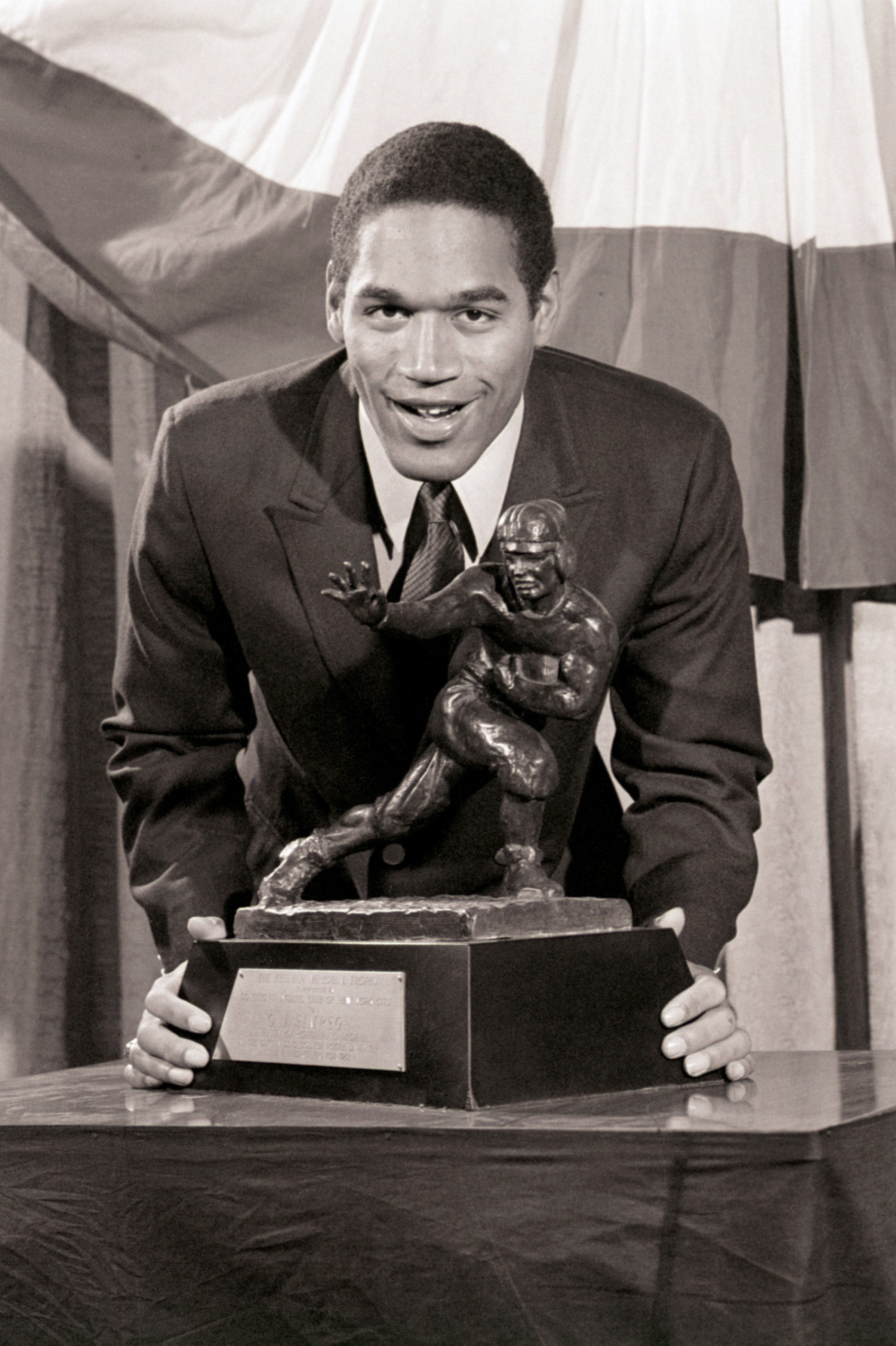 Simpson poses with the Heisman Memorial Trophy after receiving the award in 1968. 