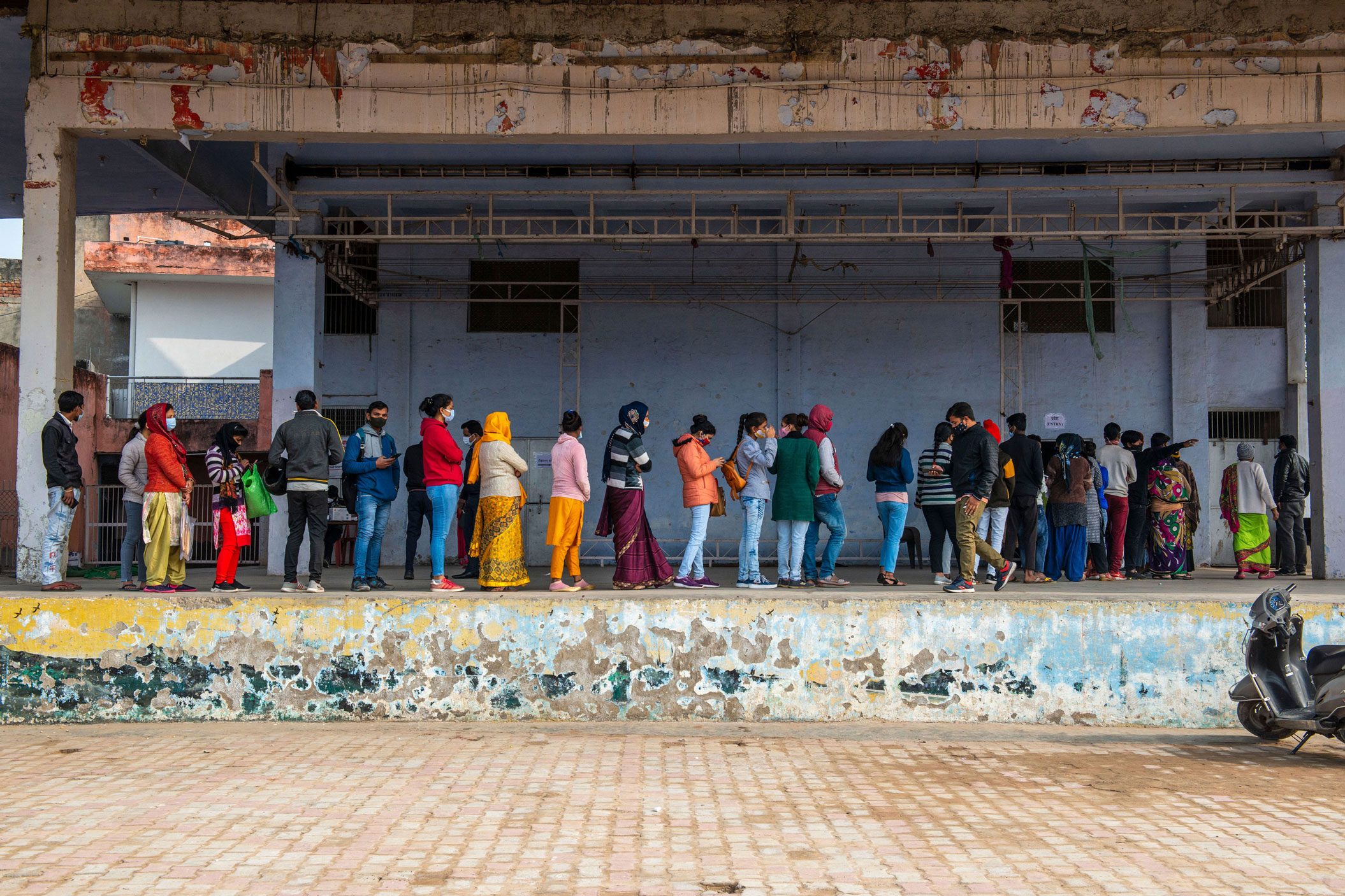 People line up to get vaccinated outside the Government Covid vaccination center in Ghaziabad, India, on January 12.