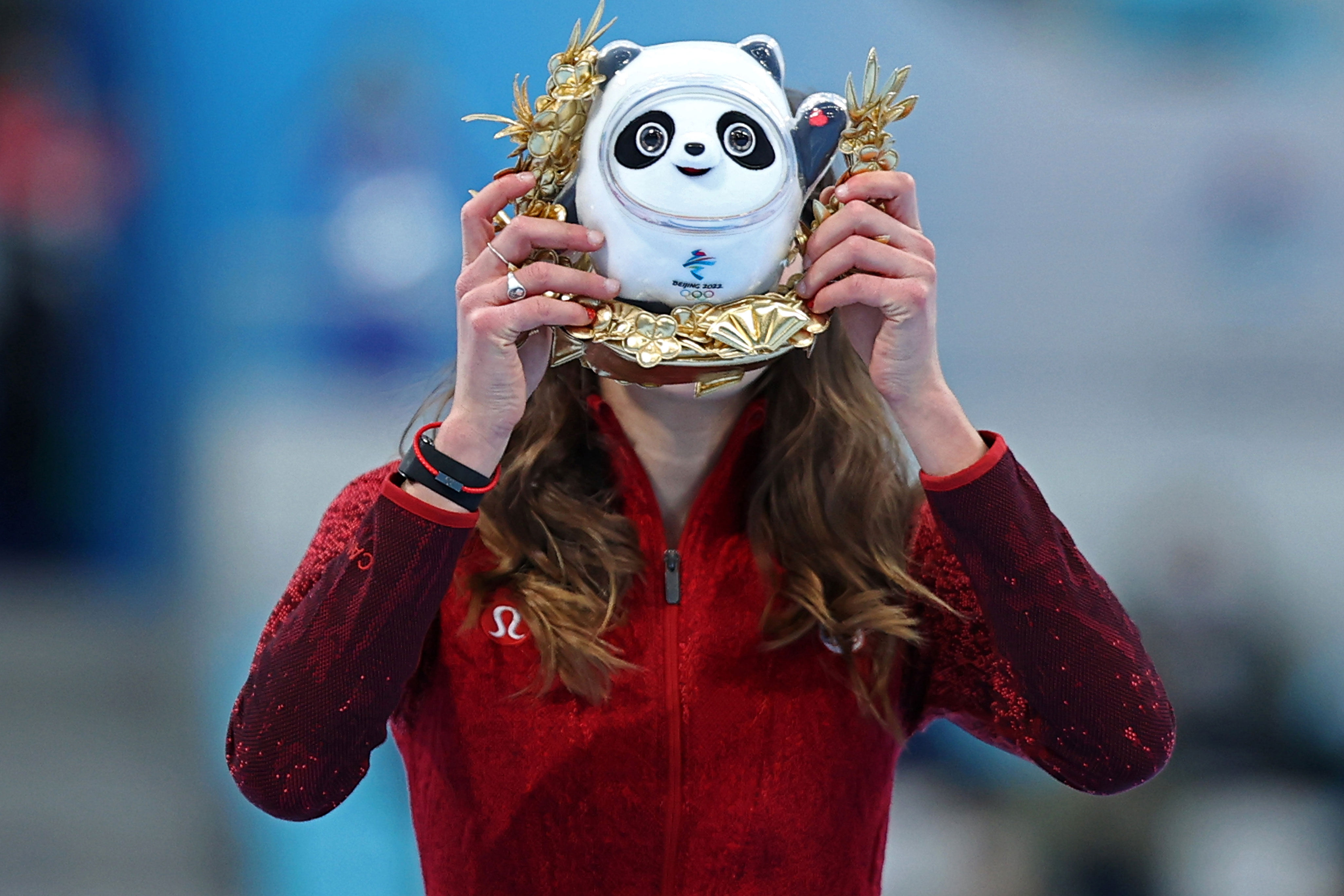 Bronze medalist Isabelle Weidemann of Canada holds up a miniature version of Olympic mascot Bing Dwen Dwen on Sunday.