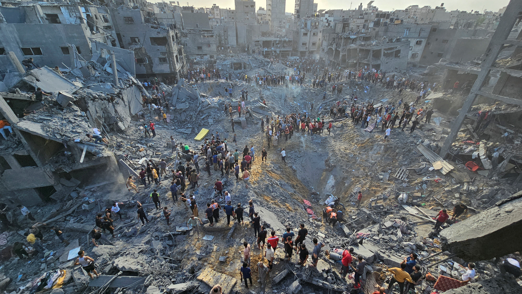 Palestinians search for casualties at the site of a strike in Jabalya Refugee Camp in Gaza on Tuesday.
