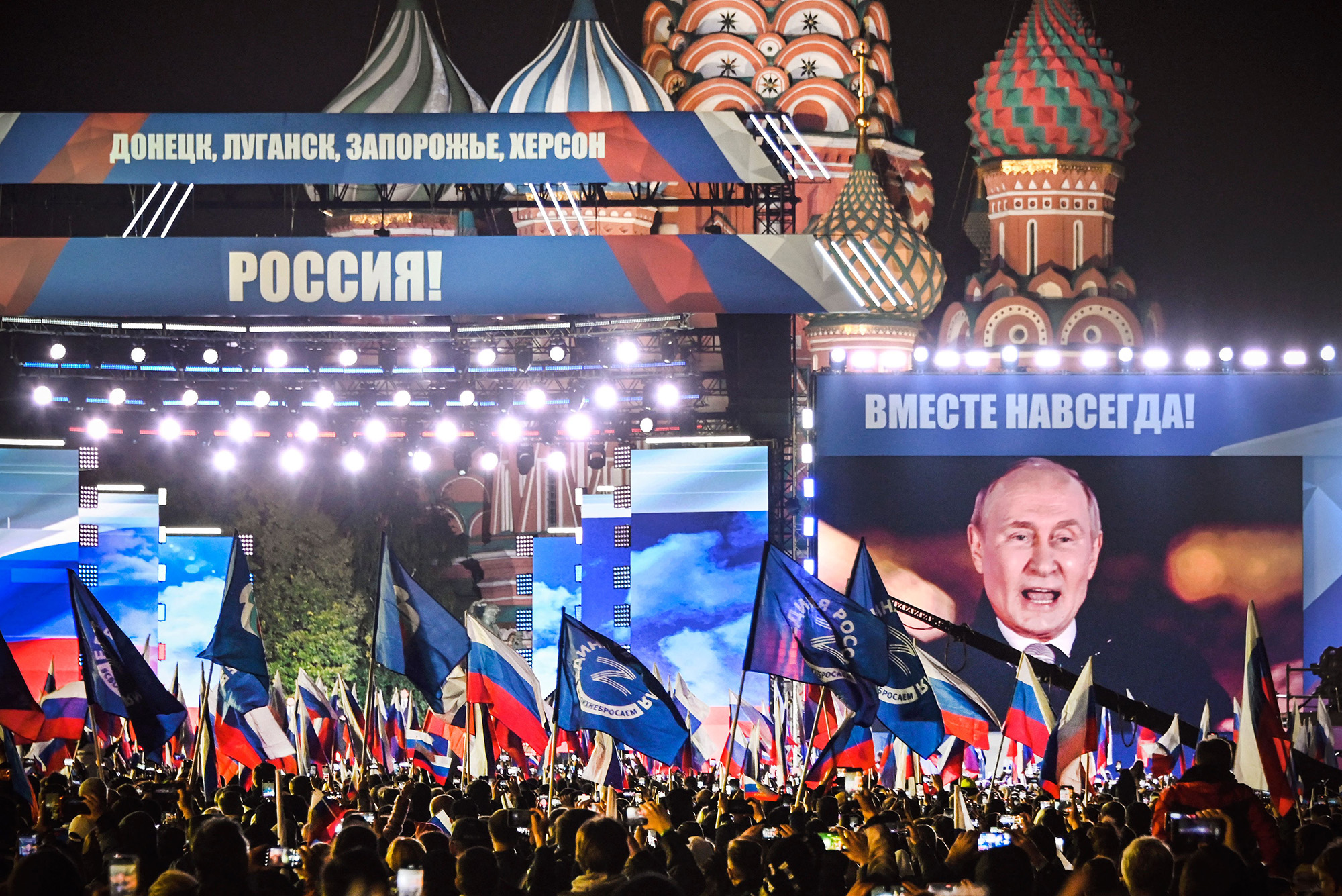 Russian President Vladimir Putin is seen on a screen set at Red Square as he addresses a rally and a concert marking the annexation of four regions of Ukraine - Luhansk, Donetsk, Kherson and Zaporizhzhia - in central Moscow on September 30.