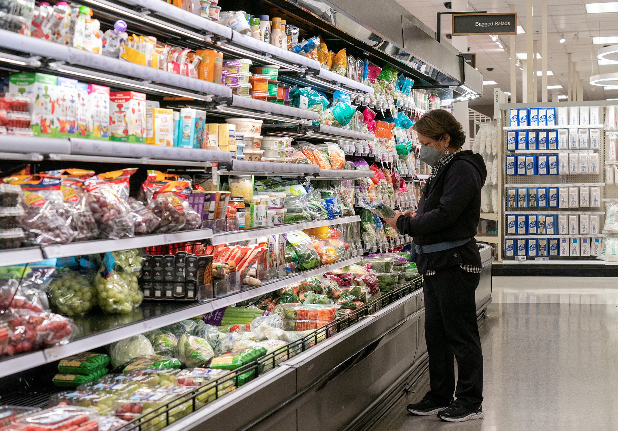 A customer selects goods at a supermarket in San Mateo, California, on November 29.