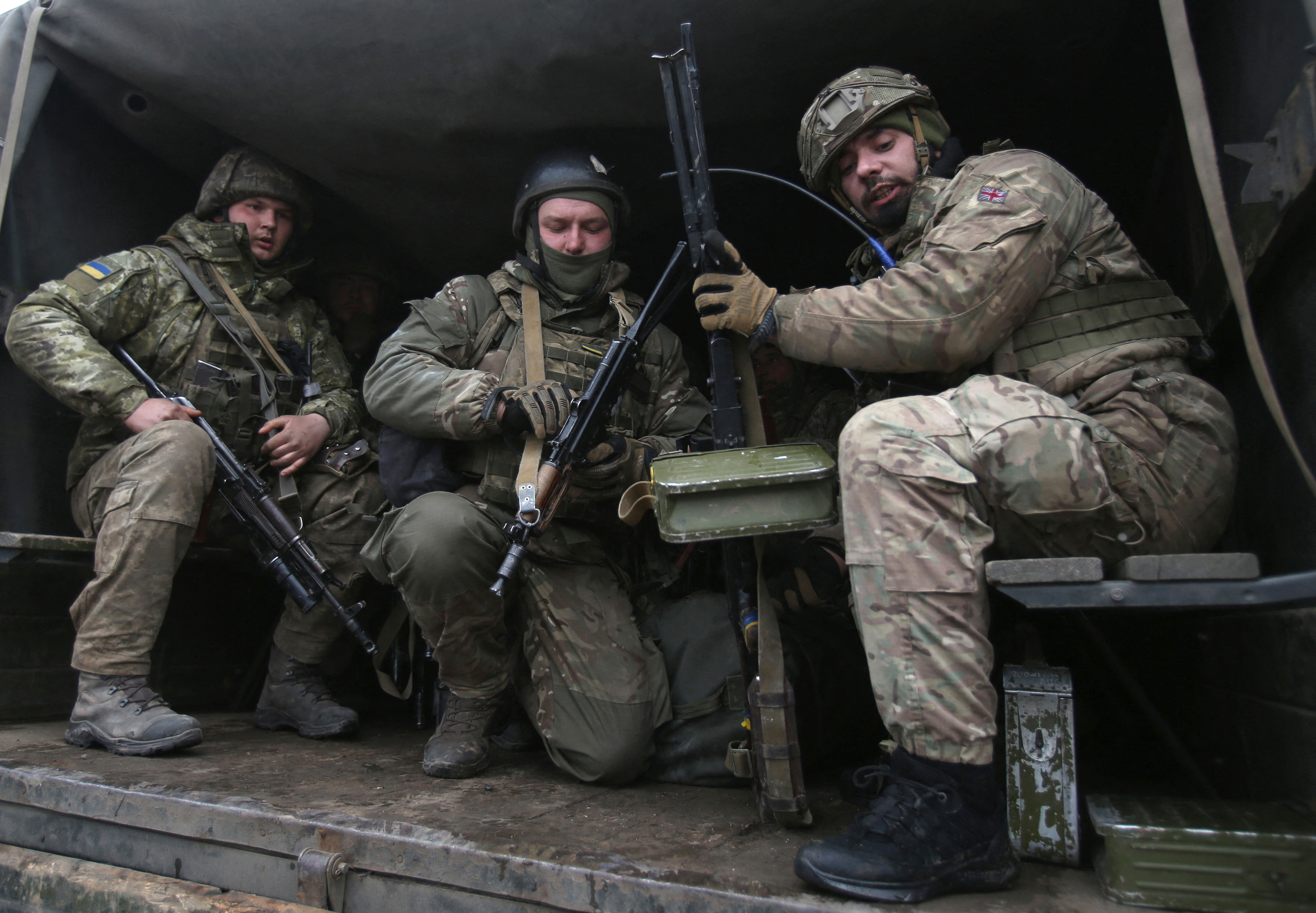 Servicemen of the Ukrainian Military Forces move to their position in the Luhansk region of Ukraine on March 8.