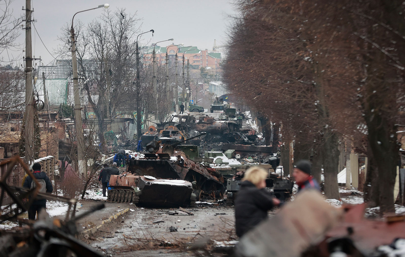The remains of Russian military vehicles line a road in Bucha, Ukraine, on March 1.