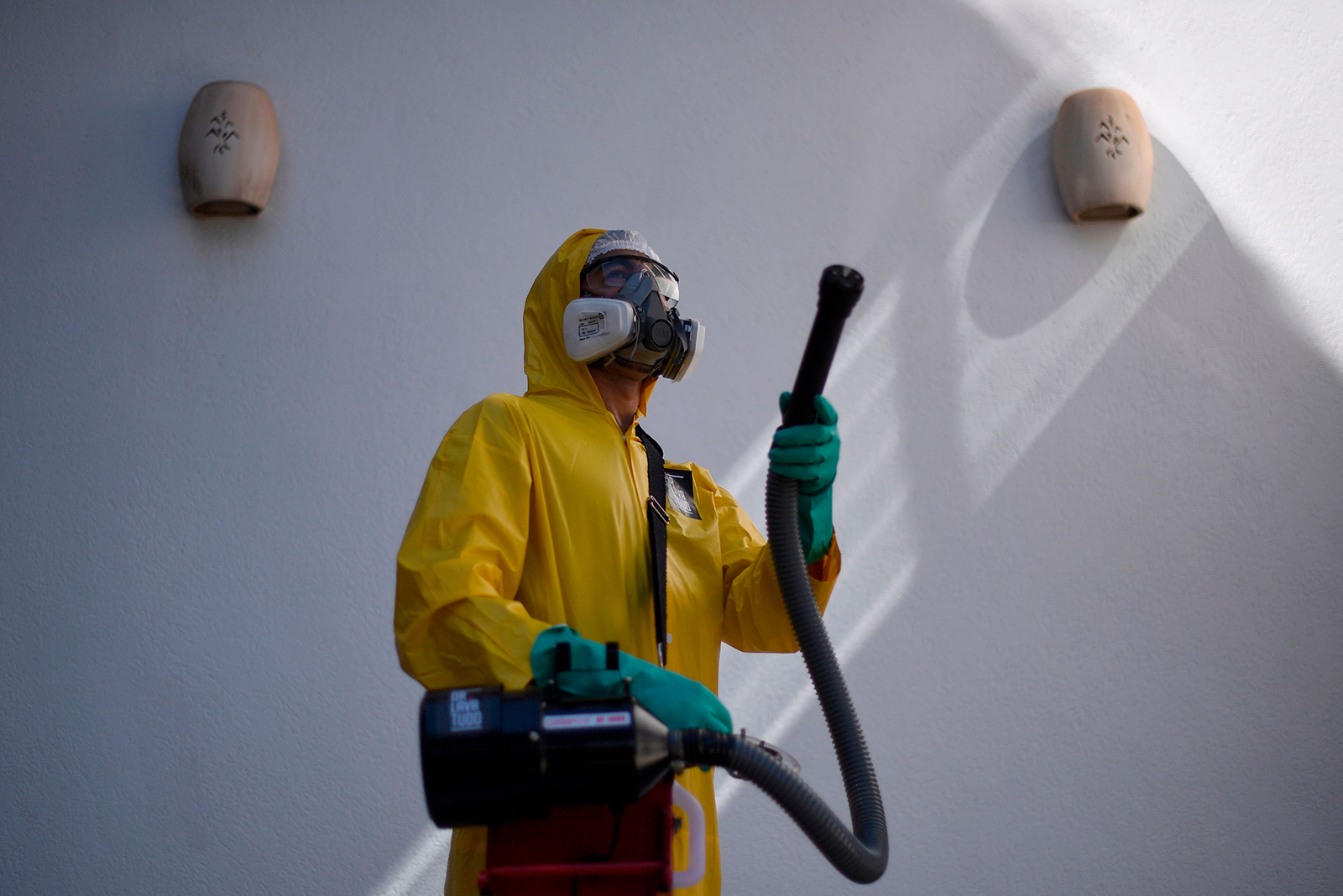 An employee of a private company sanitizes against the spread of Covid-19 at a house in Belo Horizonte, Brazil, on June 26.