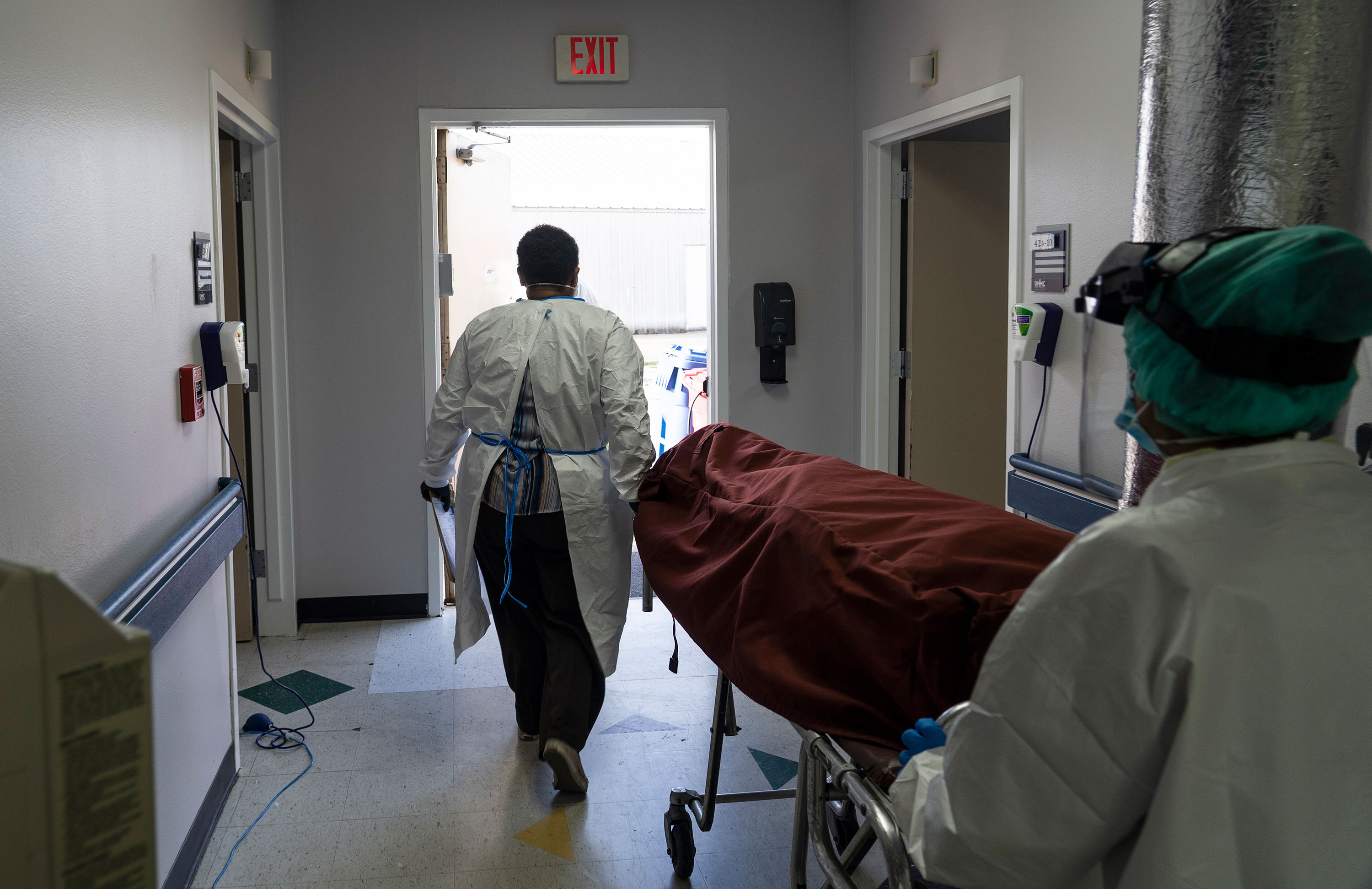 Medical staff push a stretcher with a deceased patient out of the Covid-19 intensive care unit at the United Memorial Medical Center on June 30 in Houston, Texas. 