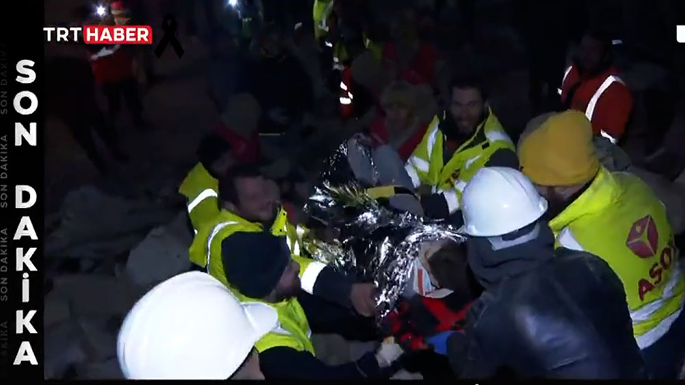 Rescuers wrap the first brother in a thermal blanket as seen on Turkish state media TRT. 