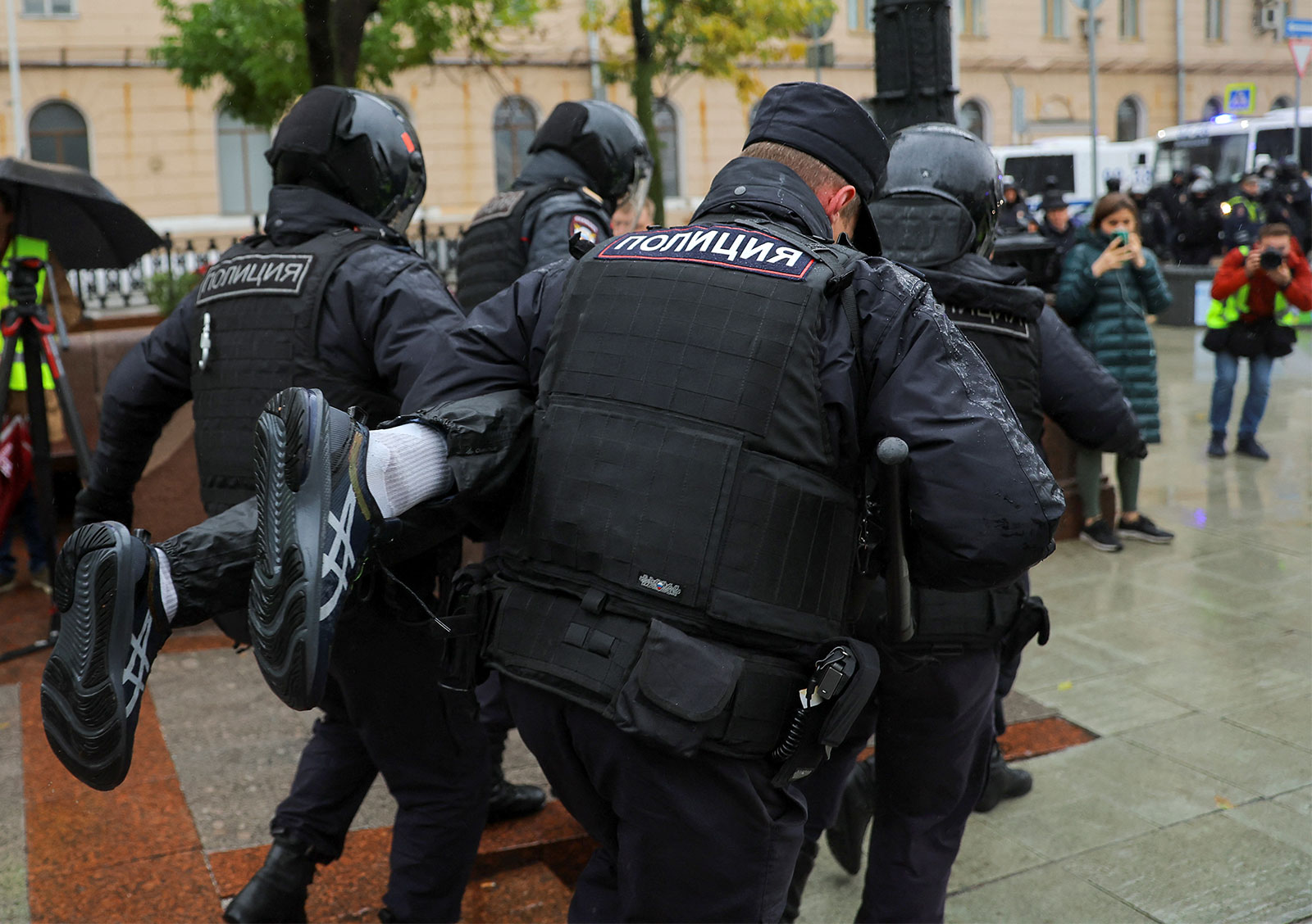Russian law enforcement officers detain a person during a rally in Moscow on September 24. 