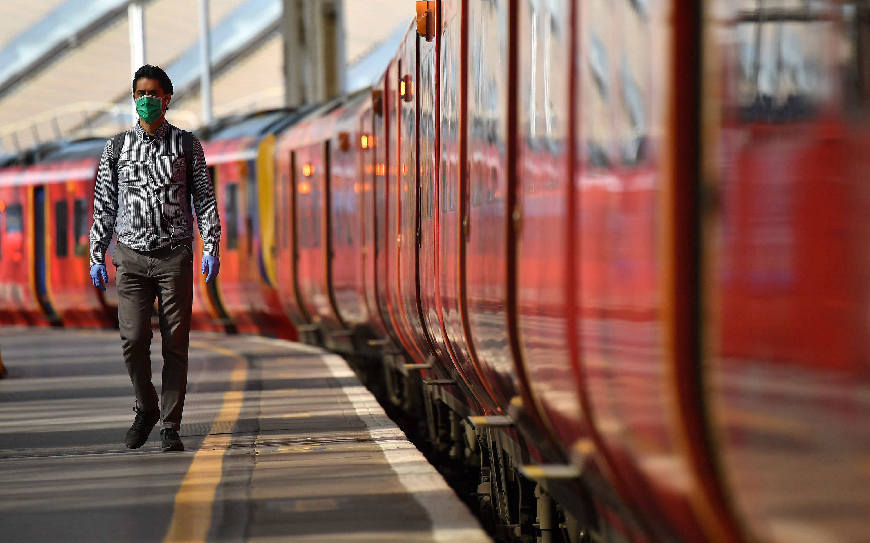 A passenger walks along a platform after arriving at Waterloo Train station in central London on May 18.