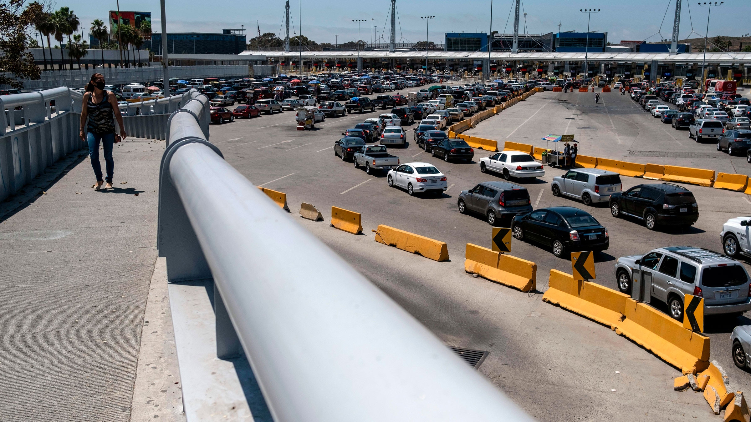 Commuters line up June 16 at the San Ysidro crossing port in Tijuana, Mexico.