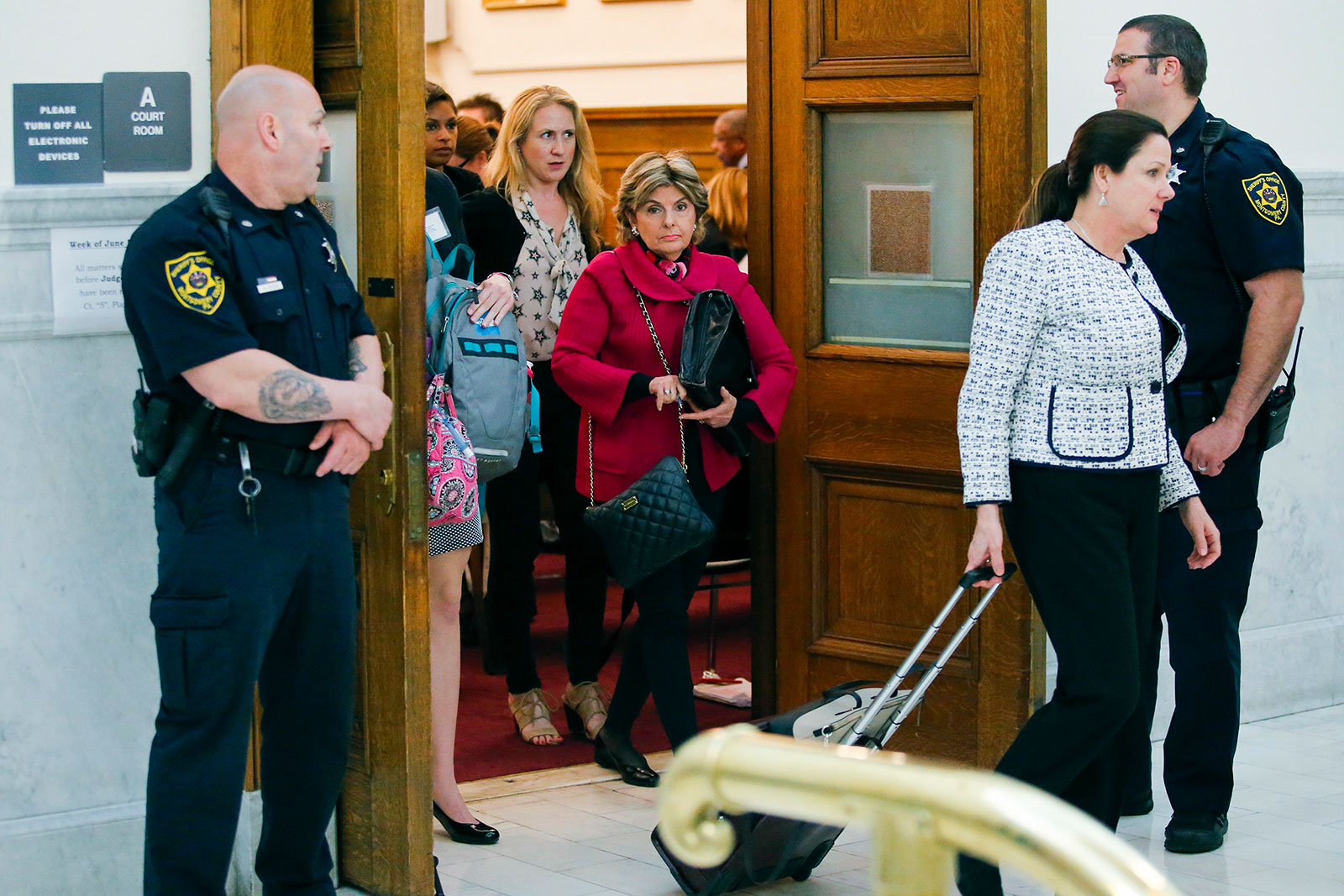 Attorney Gloria Allred, center, walks out of the courtroom at Montgomery County courthouse during Bill Cosby's trial in 2017.